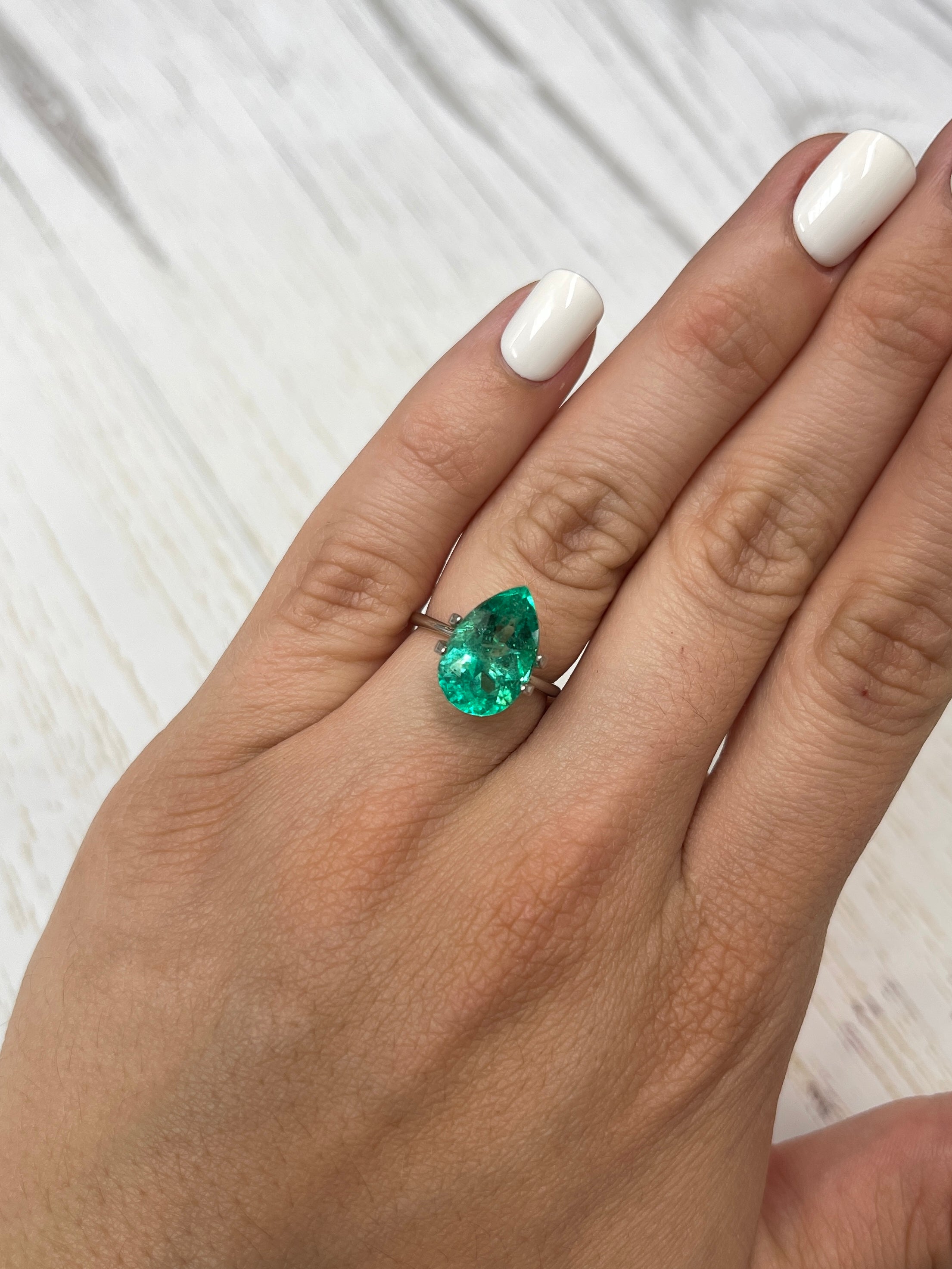 Vivid 5.21 carat natural Colombian emerald loose pear cut gemstone from JR Colombian Emeralds on a white background