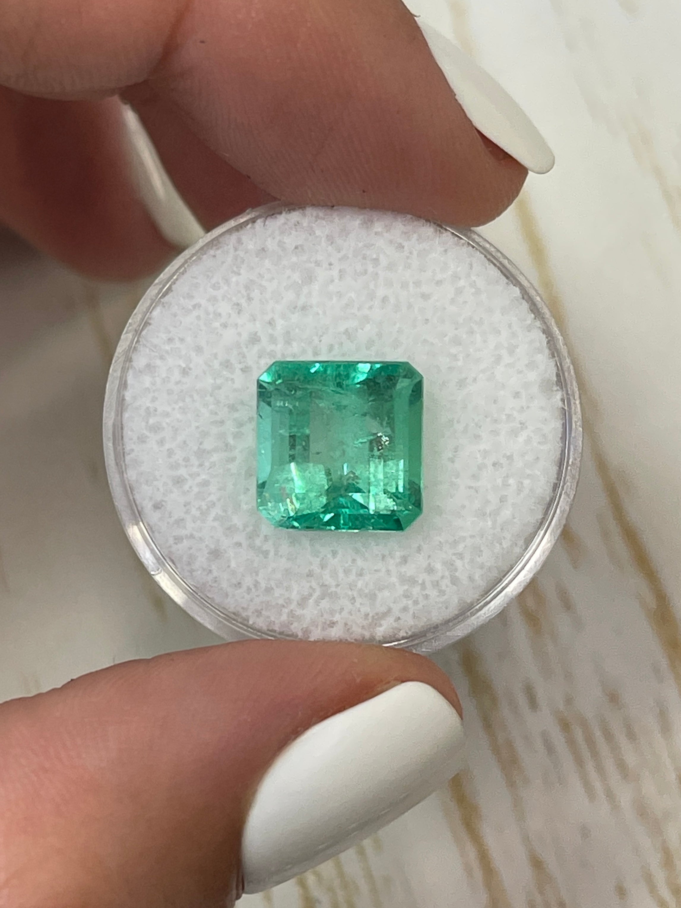 Natural 5.32 carat green Colombian emerald loose gemstone in Asscher cut, showcasing vibrant, glowing green color and clarity.