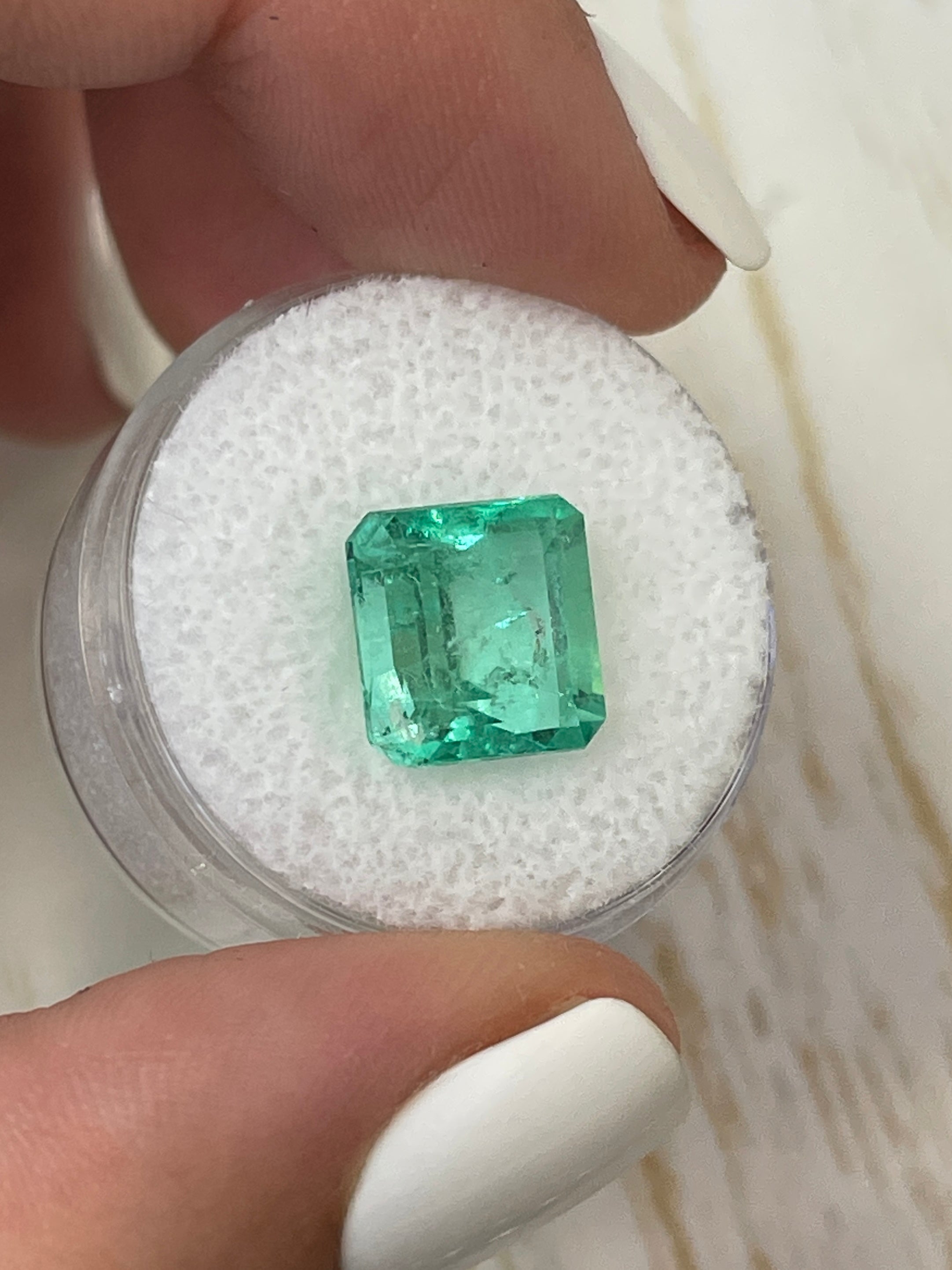 5.32 carat natural Colombian emerald loose gemstone in Asscher cut, vibrant green and glowing, from JR Colombian Emeralds.