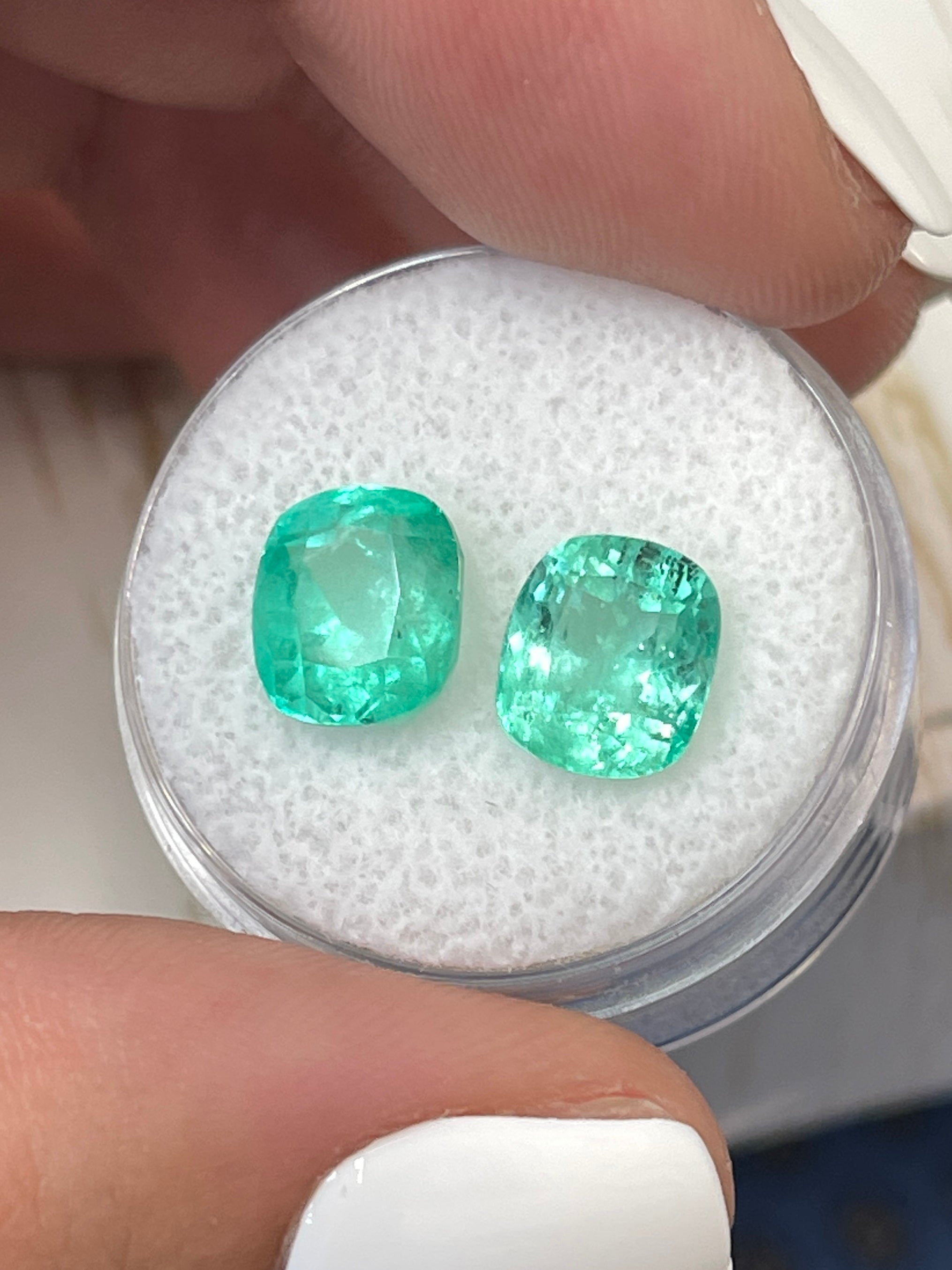 Pair of light bluish green Colombian Emeralds, 9x8mm cushion cut, natural loose gemstones from JR Colombian Emeralds.
