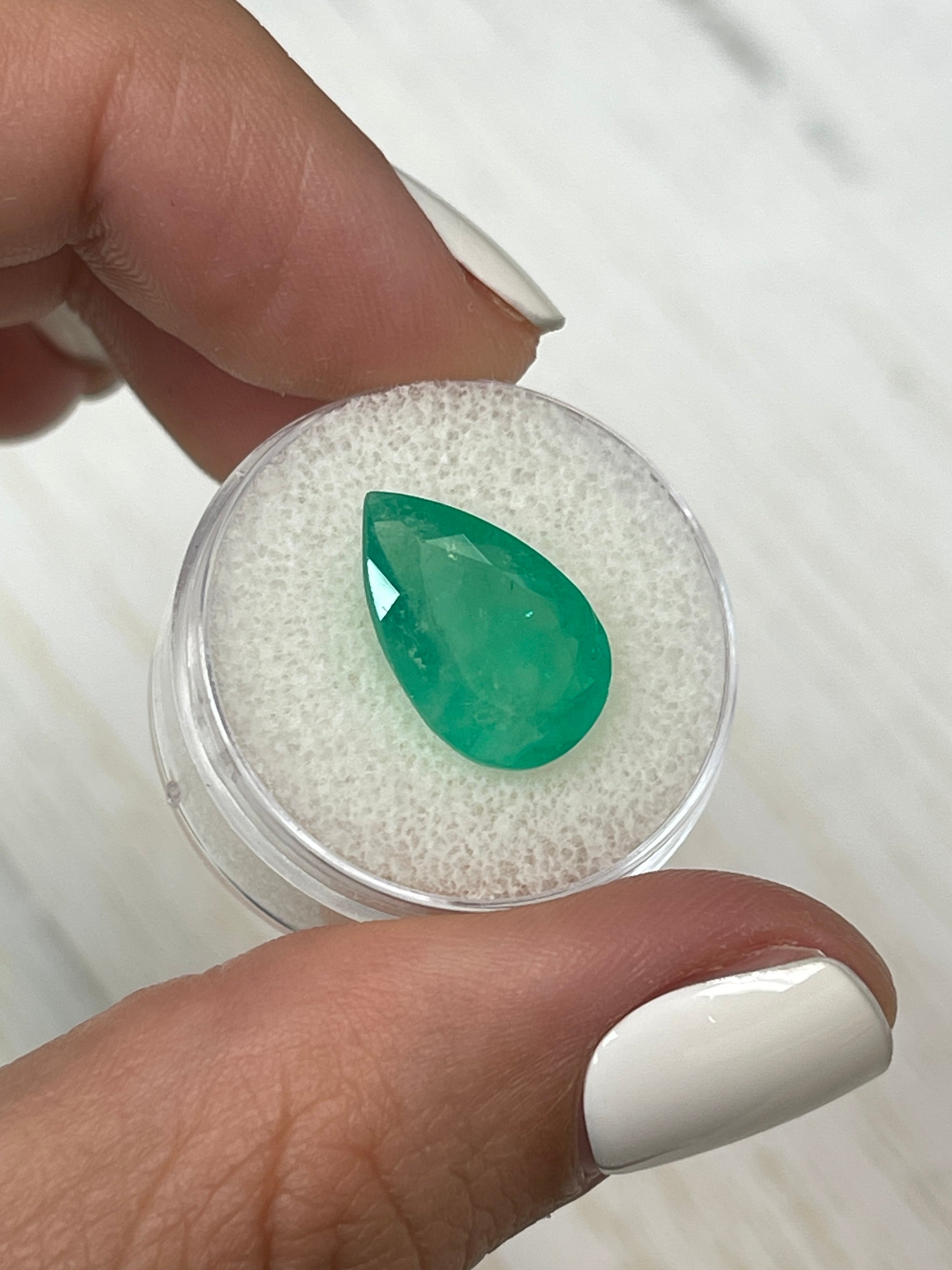 Natural 5.63 carat Apple Green Colombian Emerald loose pear cut gemstone by JR Colombian Emeralds.