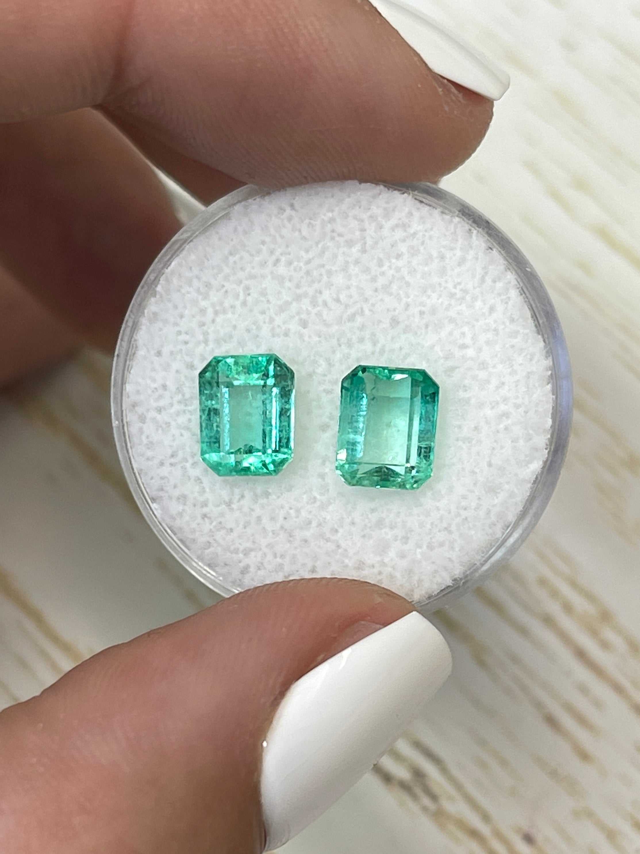 custom stud earrings with 3.35 tcw emerald-cut Colombian emeralds in vibrant medium light green