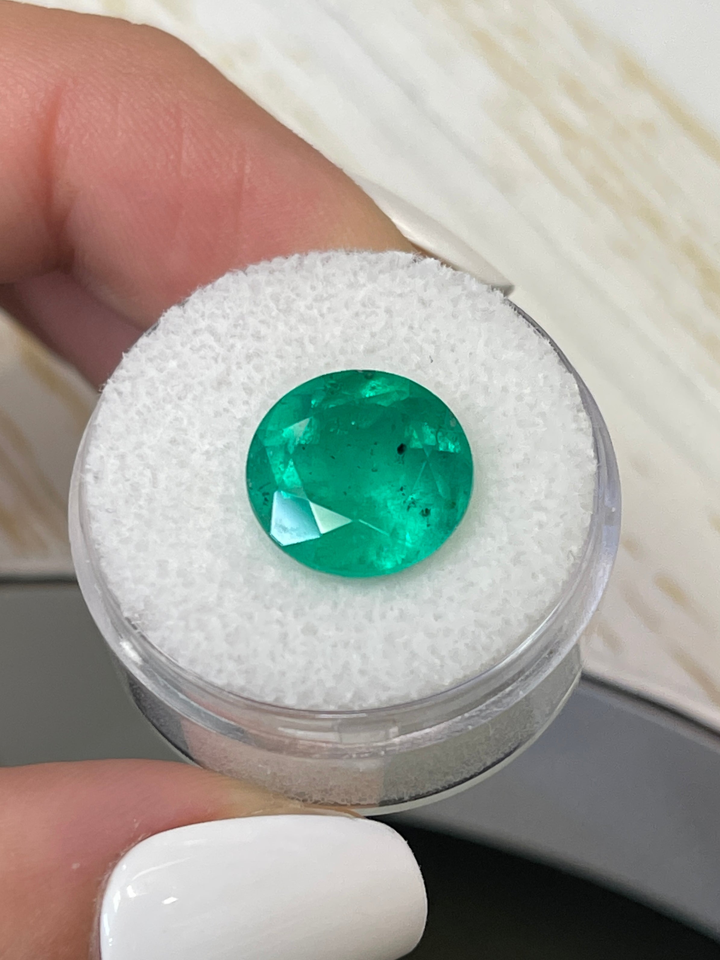 6.16 carat round green Colombian emerald loose gemstone with natural freckled surface, from JR Colombian Emeralds.
