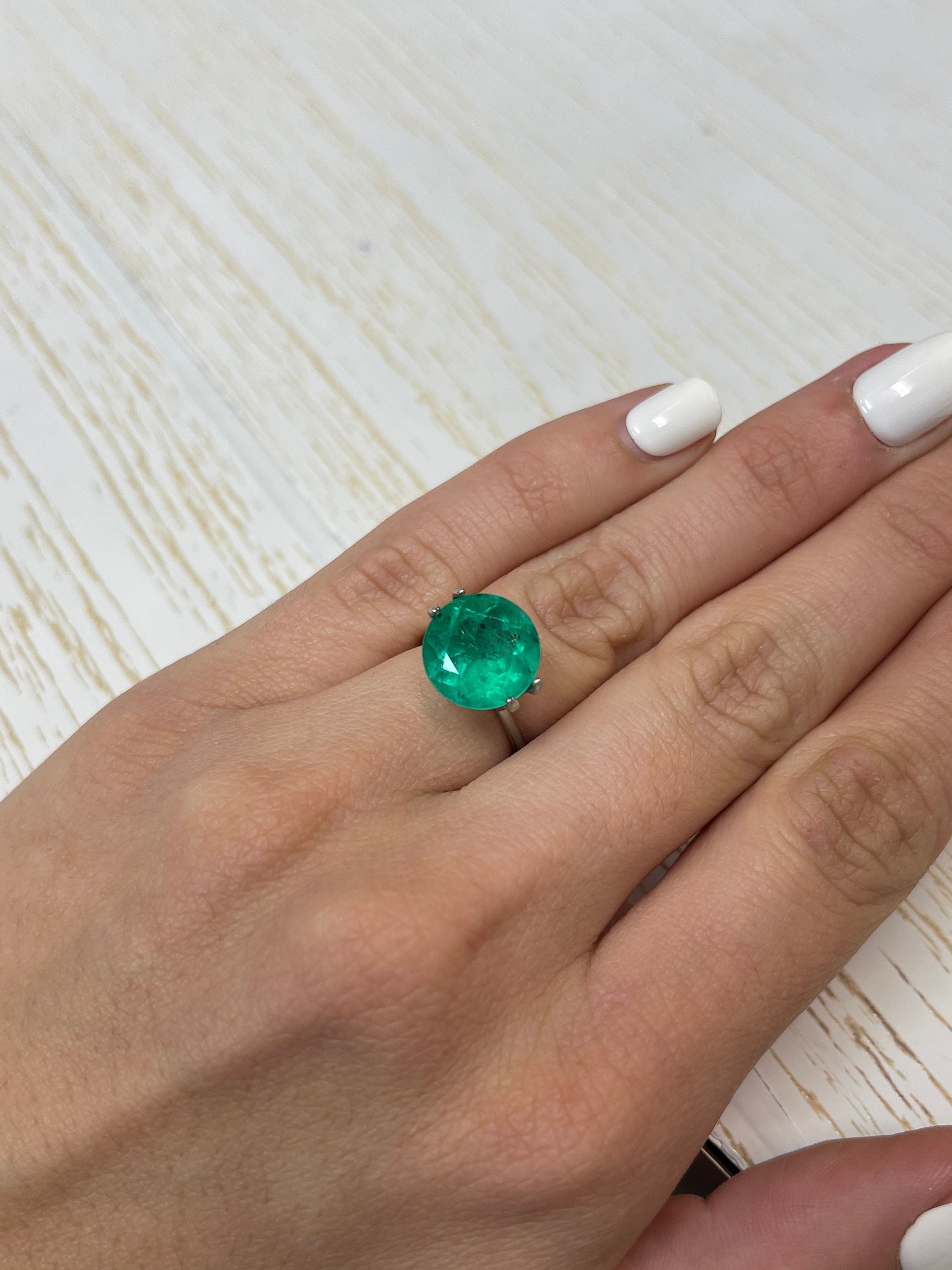 6.16-carat natural round Colombian emerald with freckled green color, loose gemstone from JR Colombian Emeralds.
