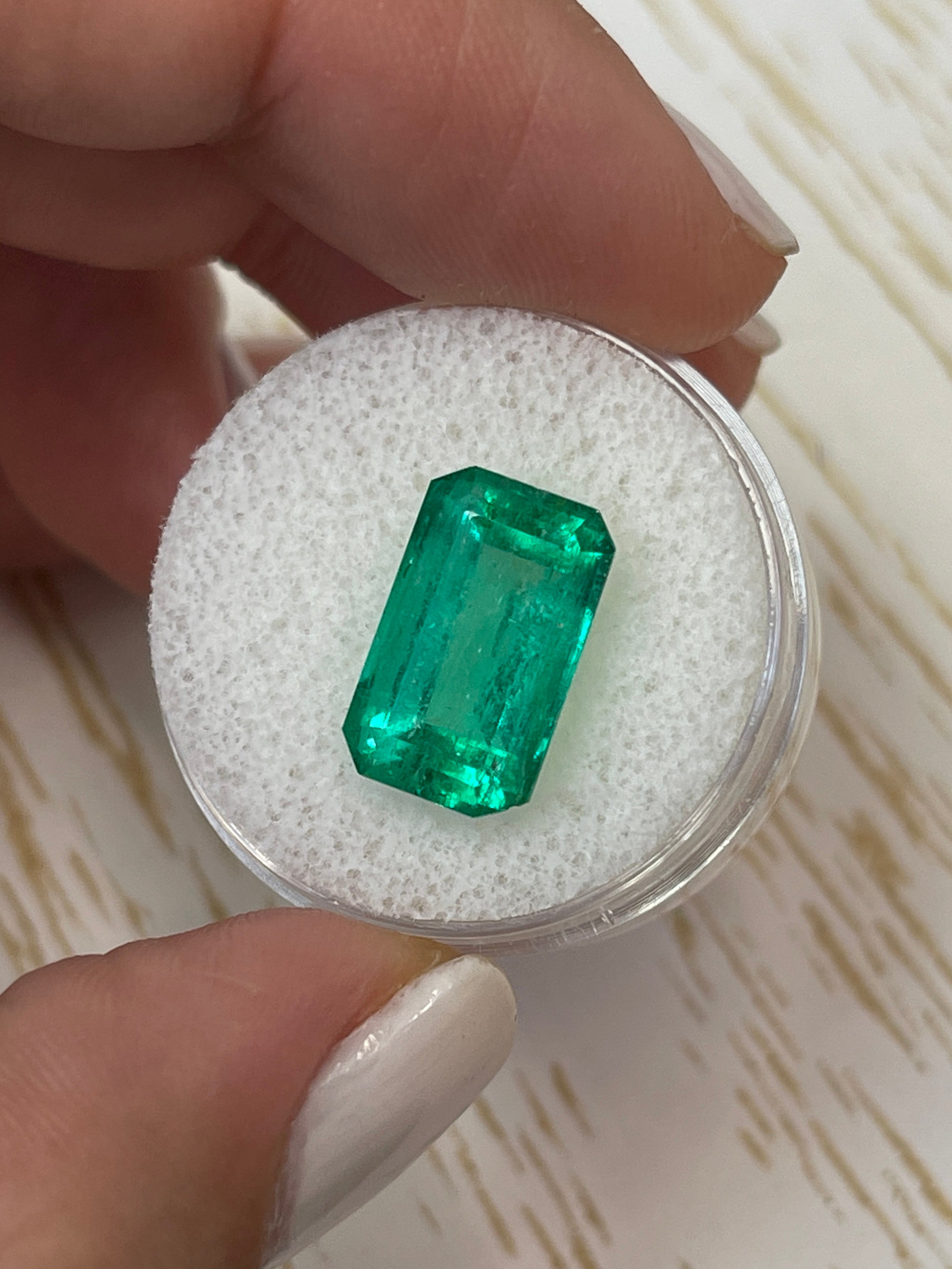 Bluish green 6.22 carat Colombian emerald cut loose gemstone from JR Colombian Emeralds, showcasing vibrant color and clarity.
