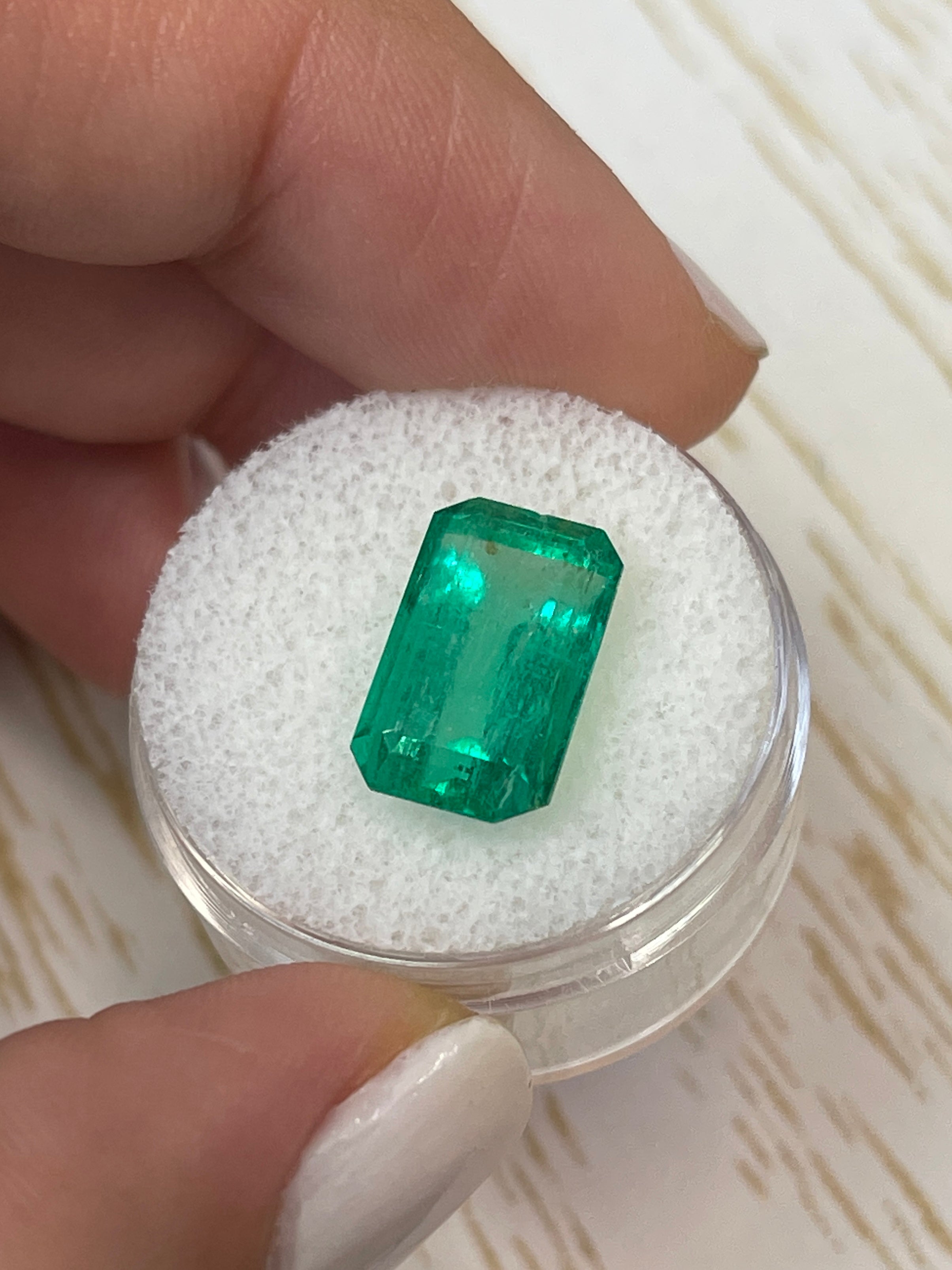 6.22 carat bluish green Colombian emerald cut loose gemstone by JR Colombian Emeralds, showcasing clarity and vibrant color.