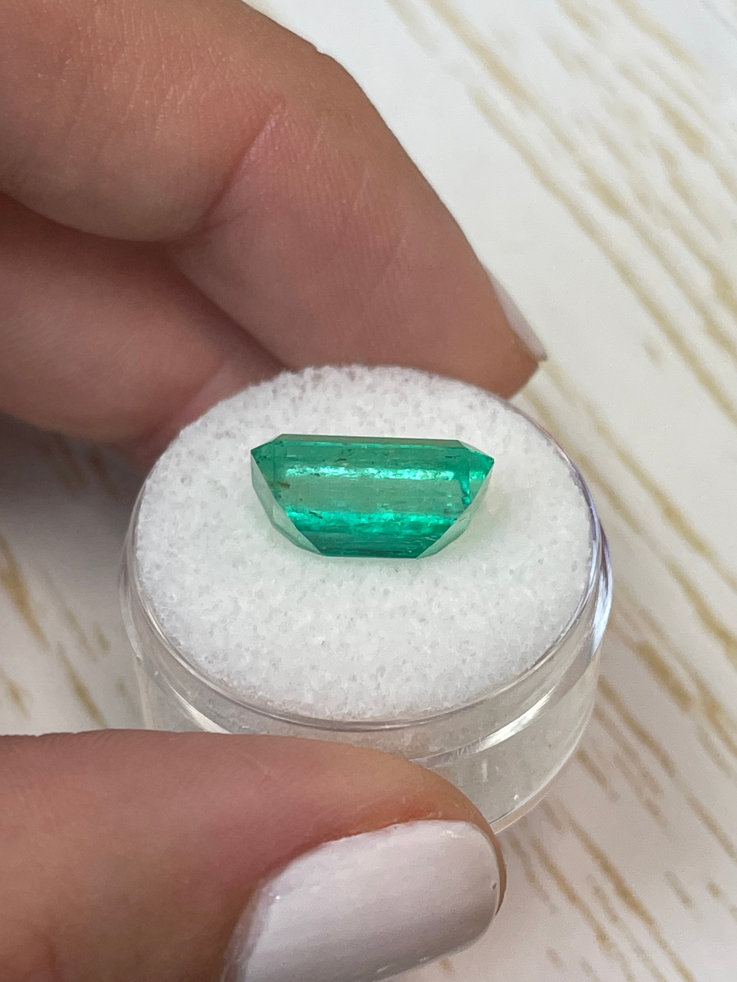 6.22 carat bluish green Colombian emerald cut loose gemstone with emerald cut, showcasing vibrant color and clarity.