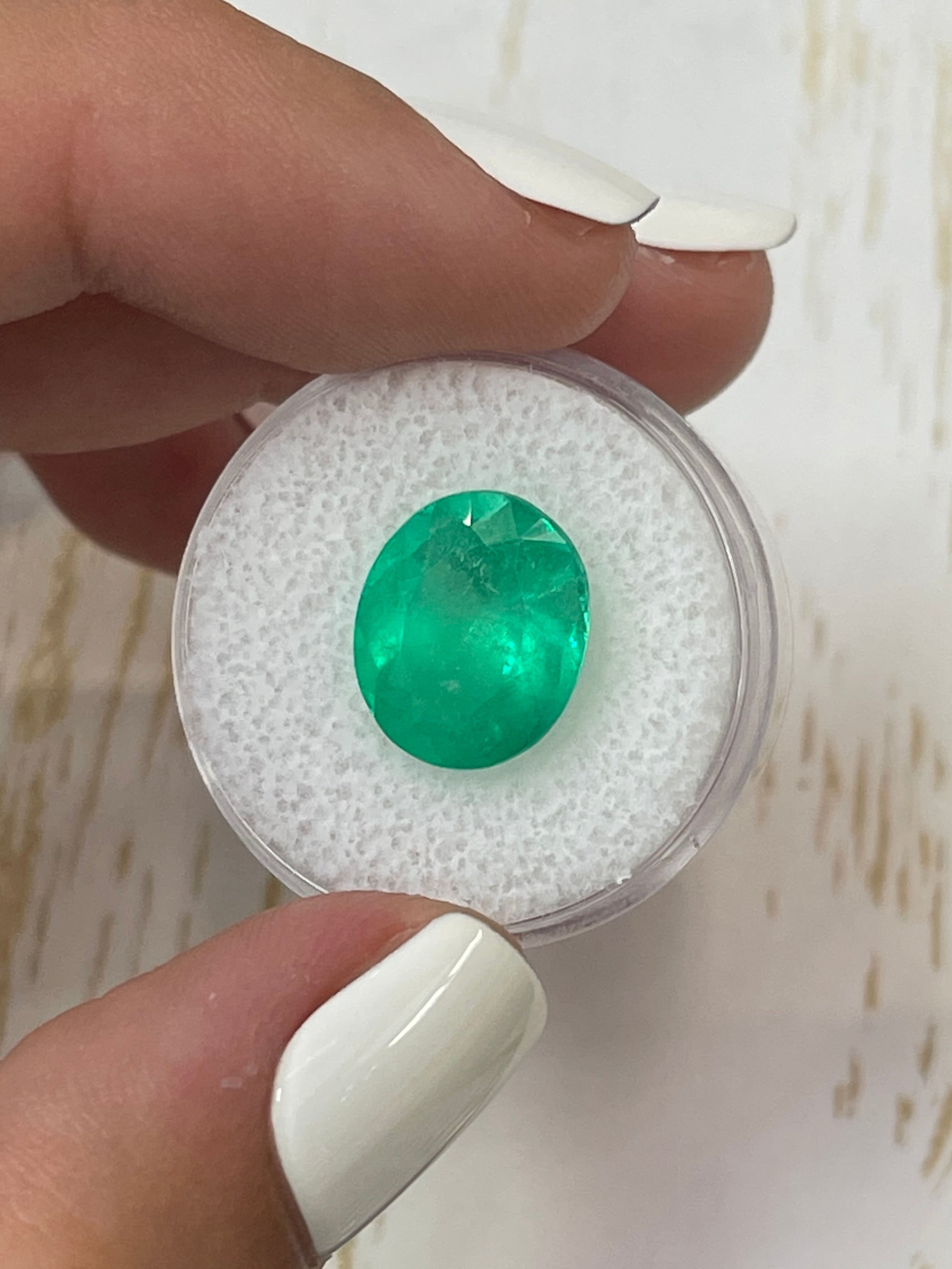 Neon green 6.35-carat oval cut Colombian emerald loose gemstone from JR Colombian Emeralds, natural and vibrant.