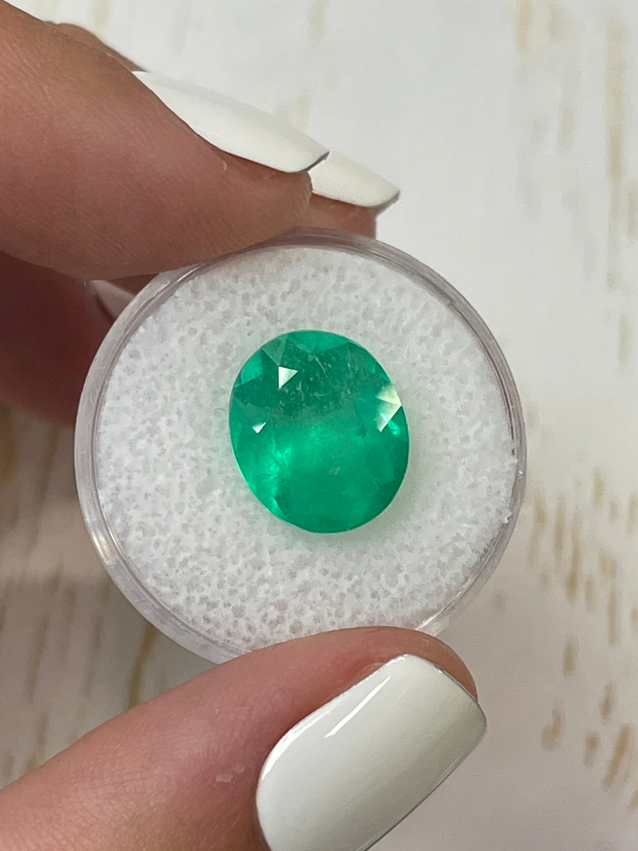 Neon green 6.35 carat oval cut Colombian emerald loose gemstone from JR Colombian Emeralds, natural and vibrant.