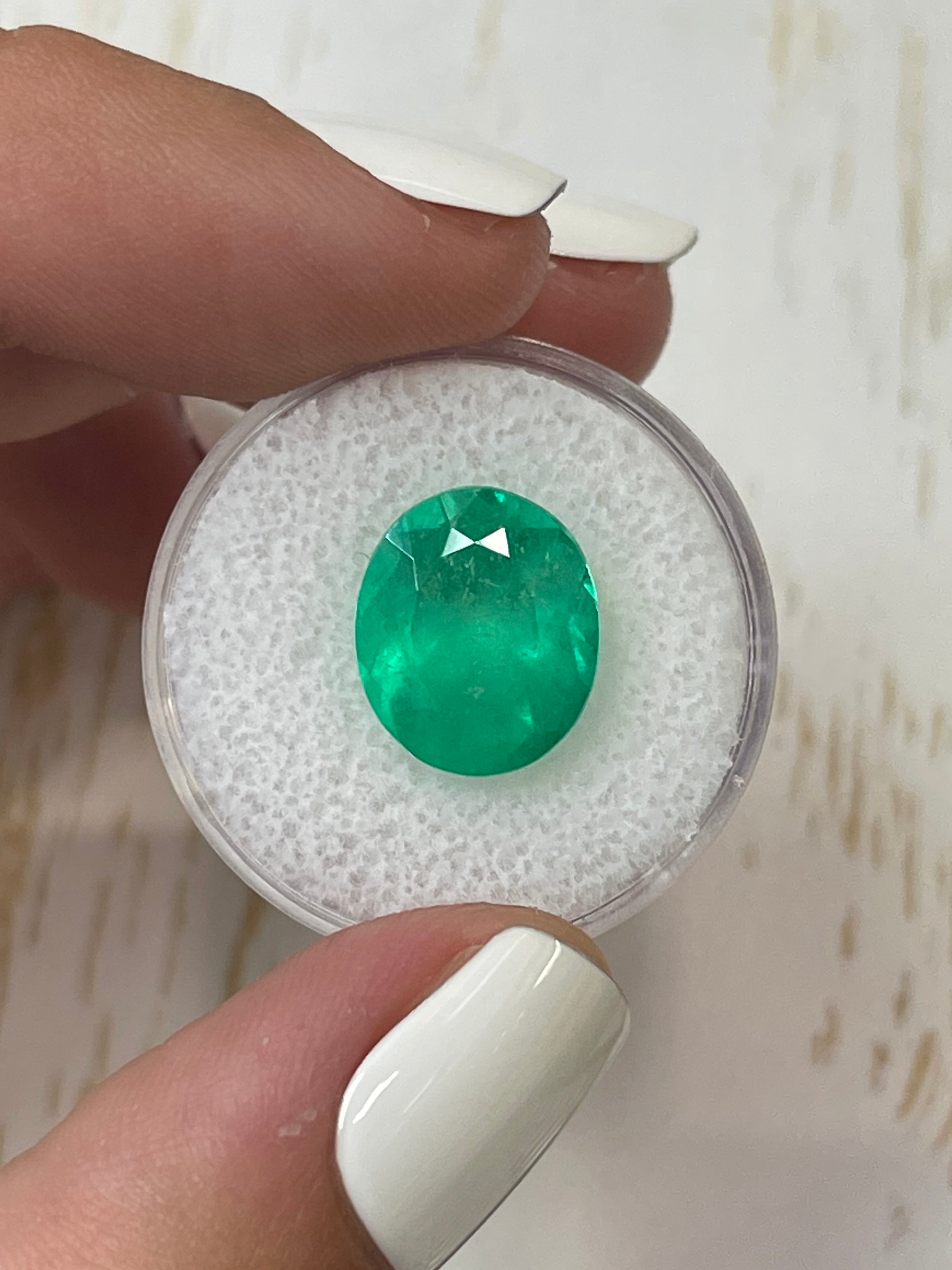 Neon green 6.35 carat natural Colombian emerald oval cut loose gemstone from JR Colombian Emeralds.