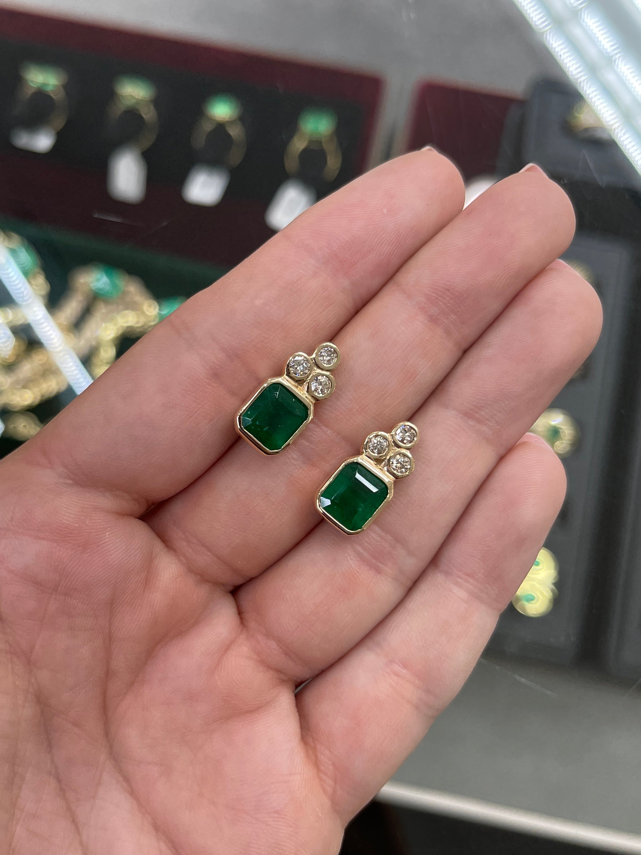 Natural dark forest green emerald cut earrings with diamond accents in 14K bezel setting by JR Colombian Emeralds.