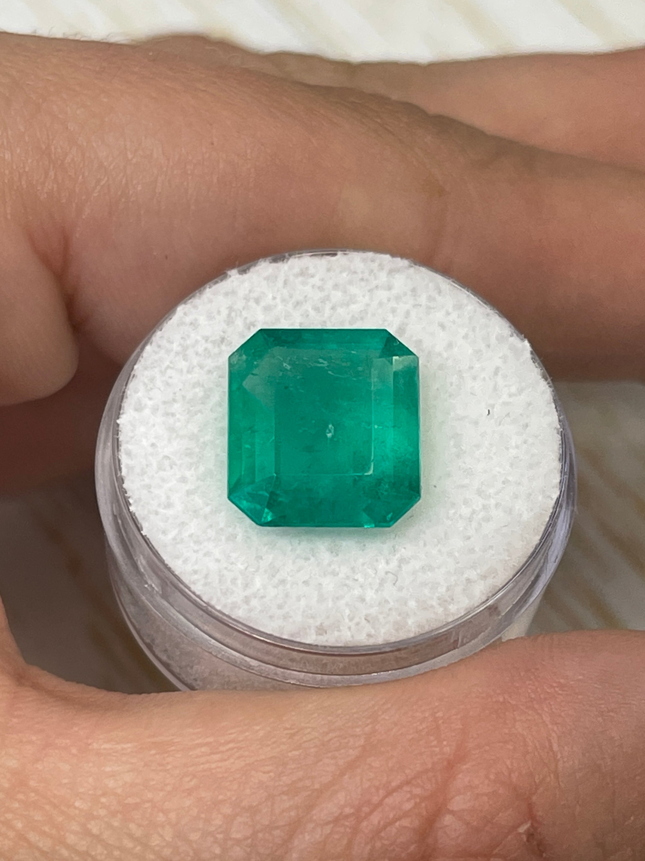 7.39-carat bluish green Colombian emerald cut loose gemstone from JR Colombian Emeralds, showcasing vibrant color and clarity.