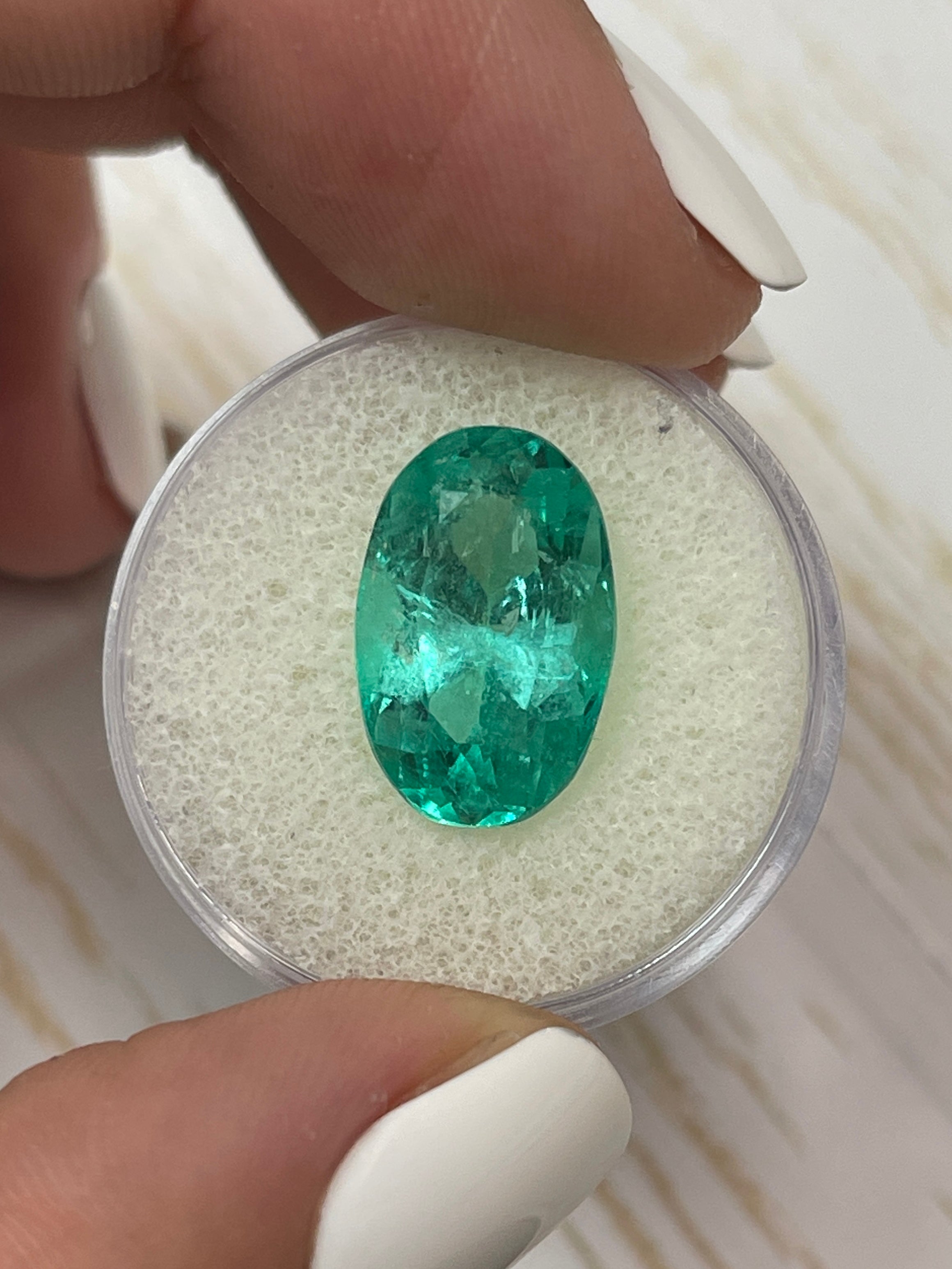 7.55 carat elongated oval-shaped bluish green Colombian emerald loose gemstone from JR Colombian Emeralds.
