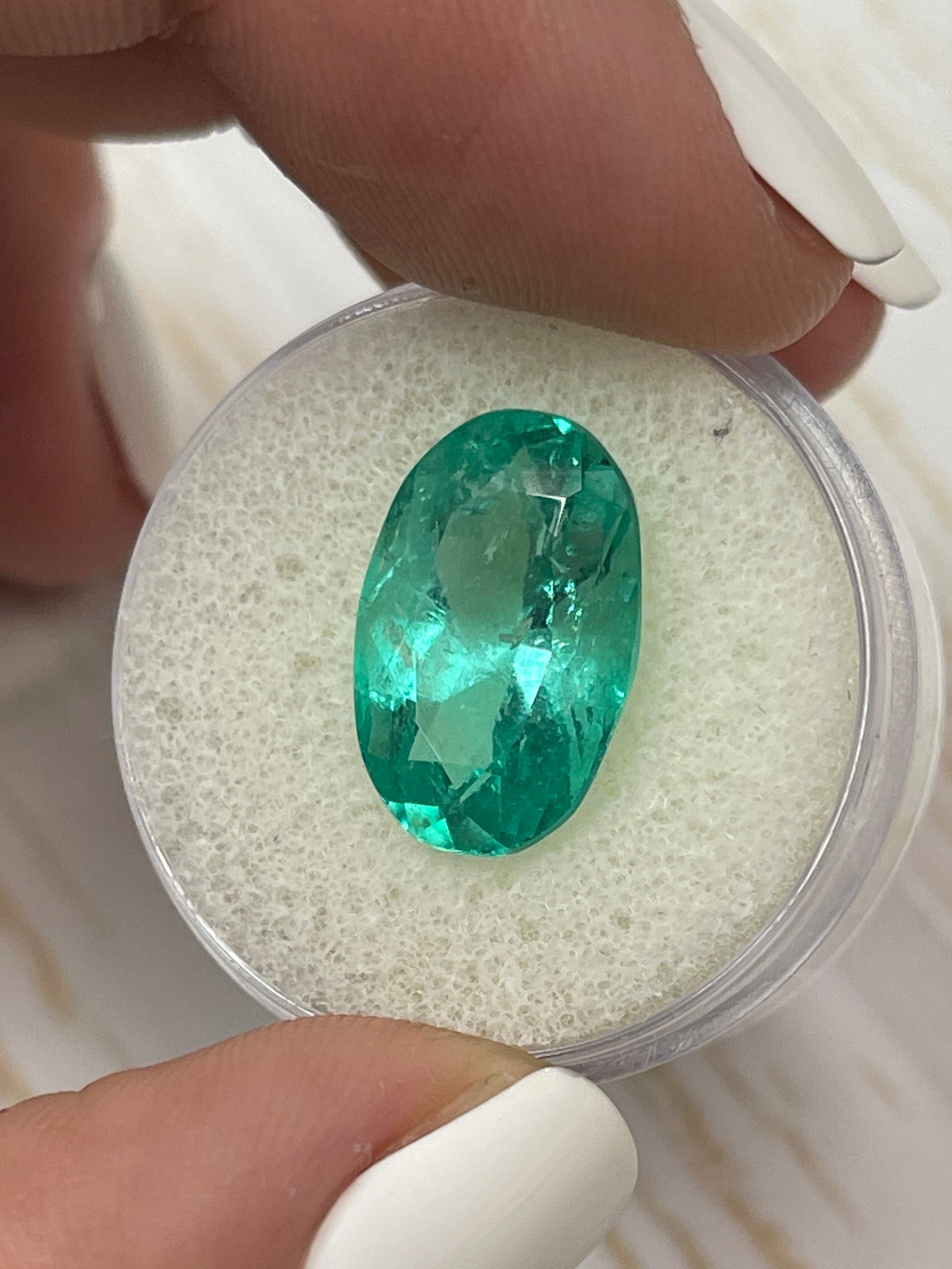7.55 carat elongated 16x10 mm bluish green natural Colombian emerald loose oval cut gemstone from JR Colombian Emeralds.
