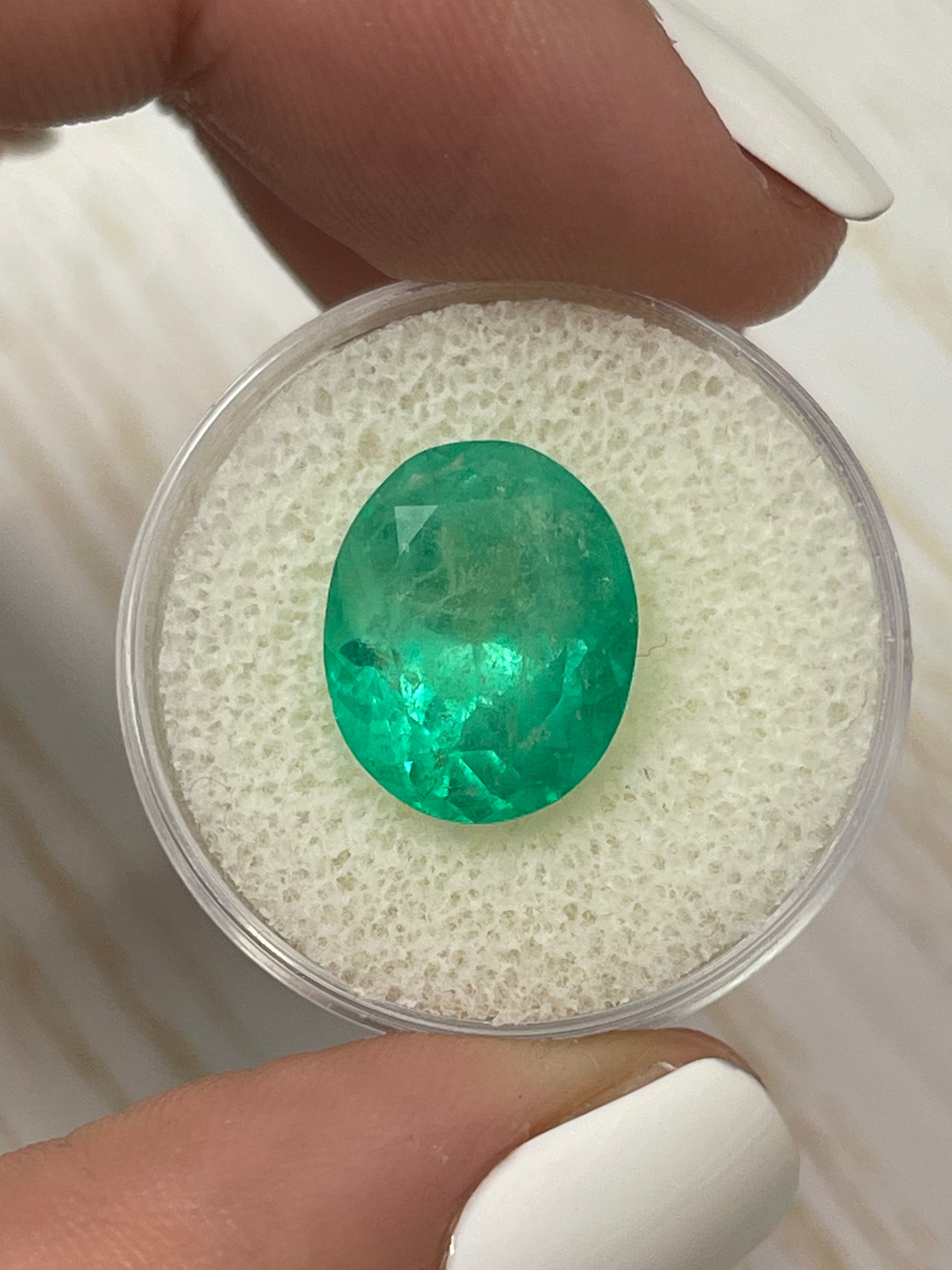 7.80 carat medium yellowish green natural Colombian emerald in oval cut, showcased as a loose gemstone with vibrant color.