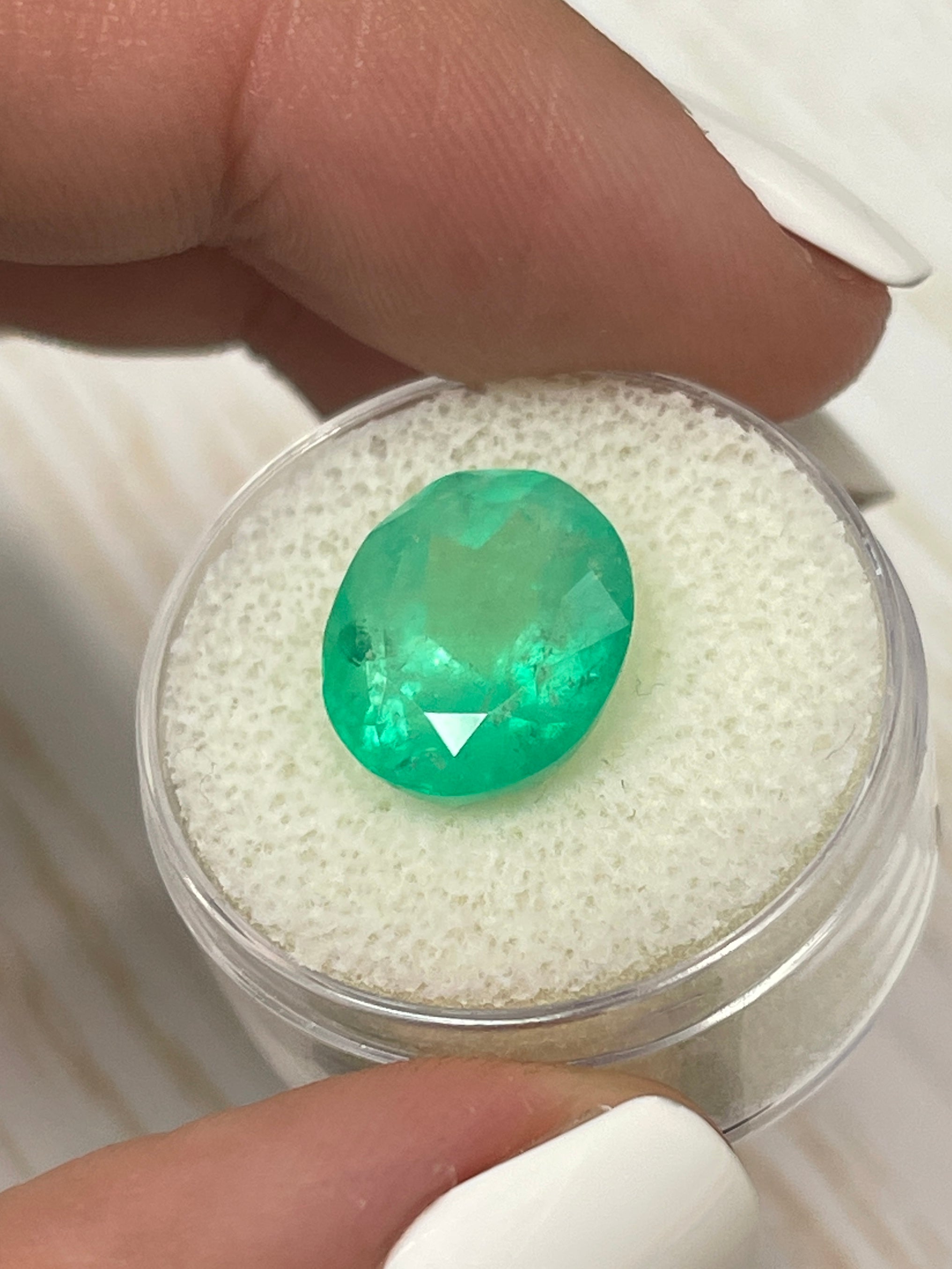 7.80 carat medium yellowish green natural Colombian emerald loose oval cut gemstone from JR Colombian Emeralds.