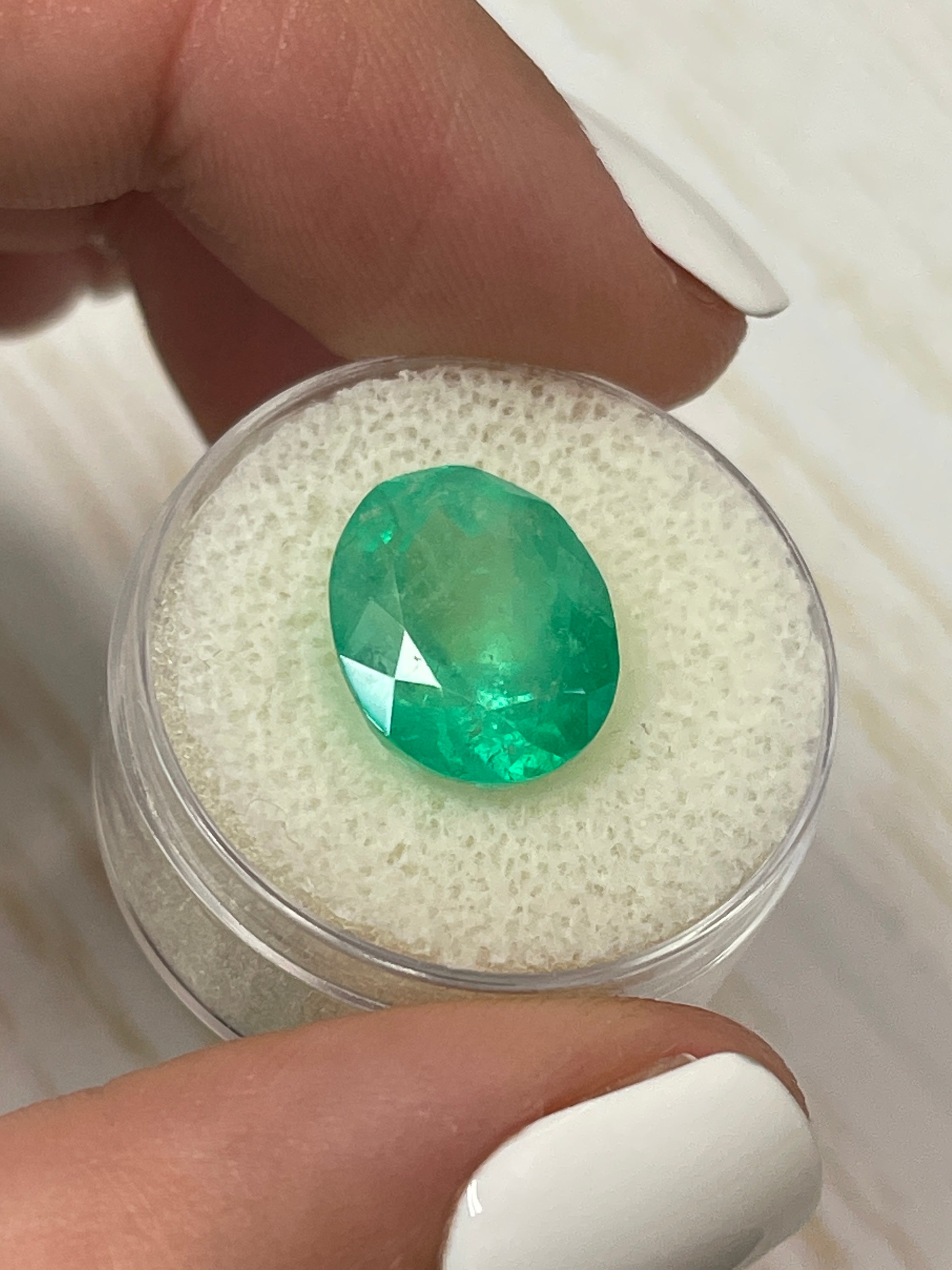 Medium yellowish-green 7.80 carat natural Colombian emerald in oval cut, loose gemstone from JR Colombian Emeralds.