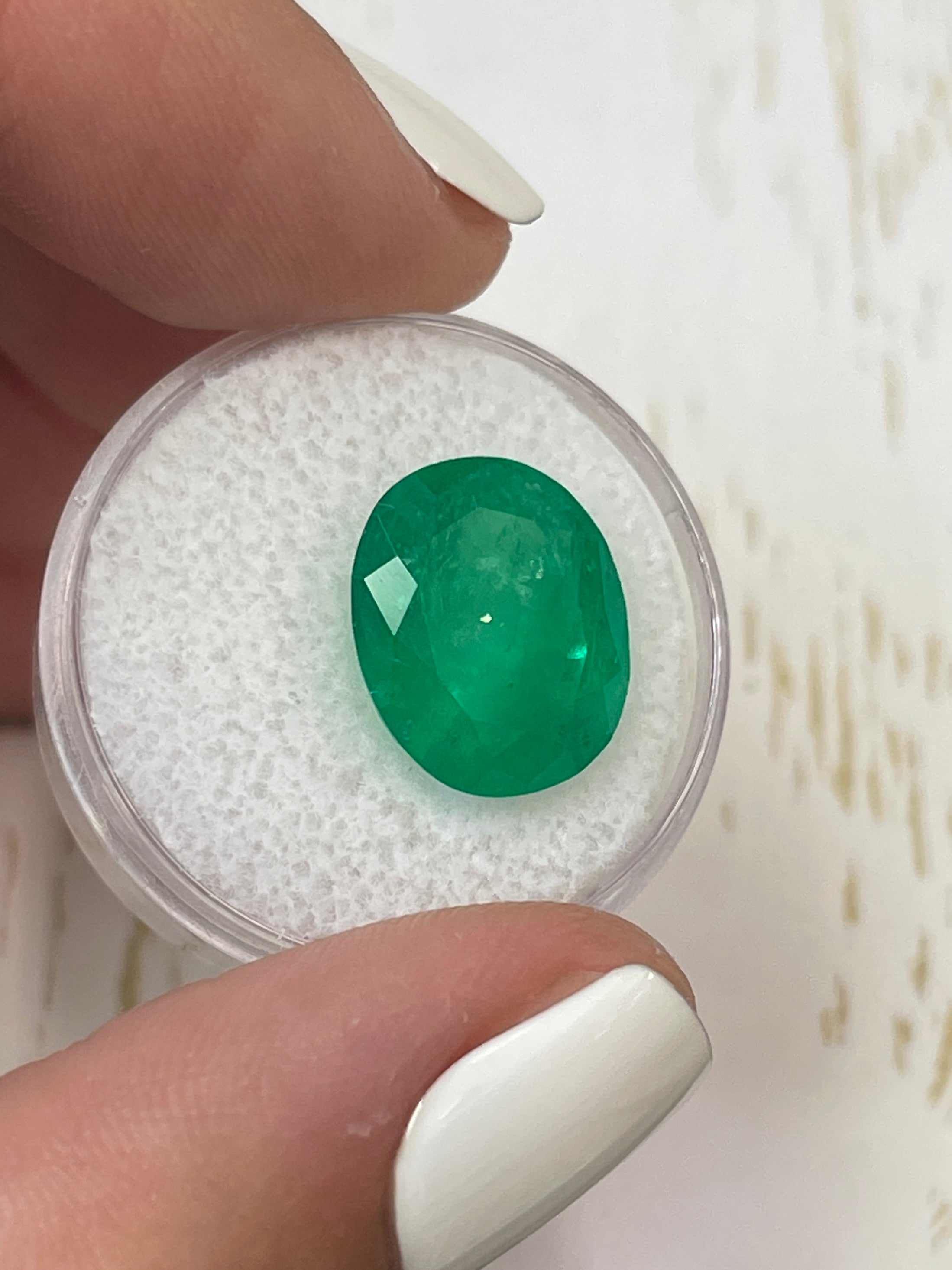 Deep green 8.29 carat oval cut Colombian emerald from JR Colombian Emeralds, natural loose gemstone.