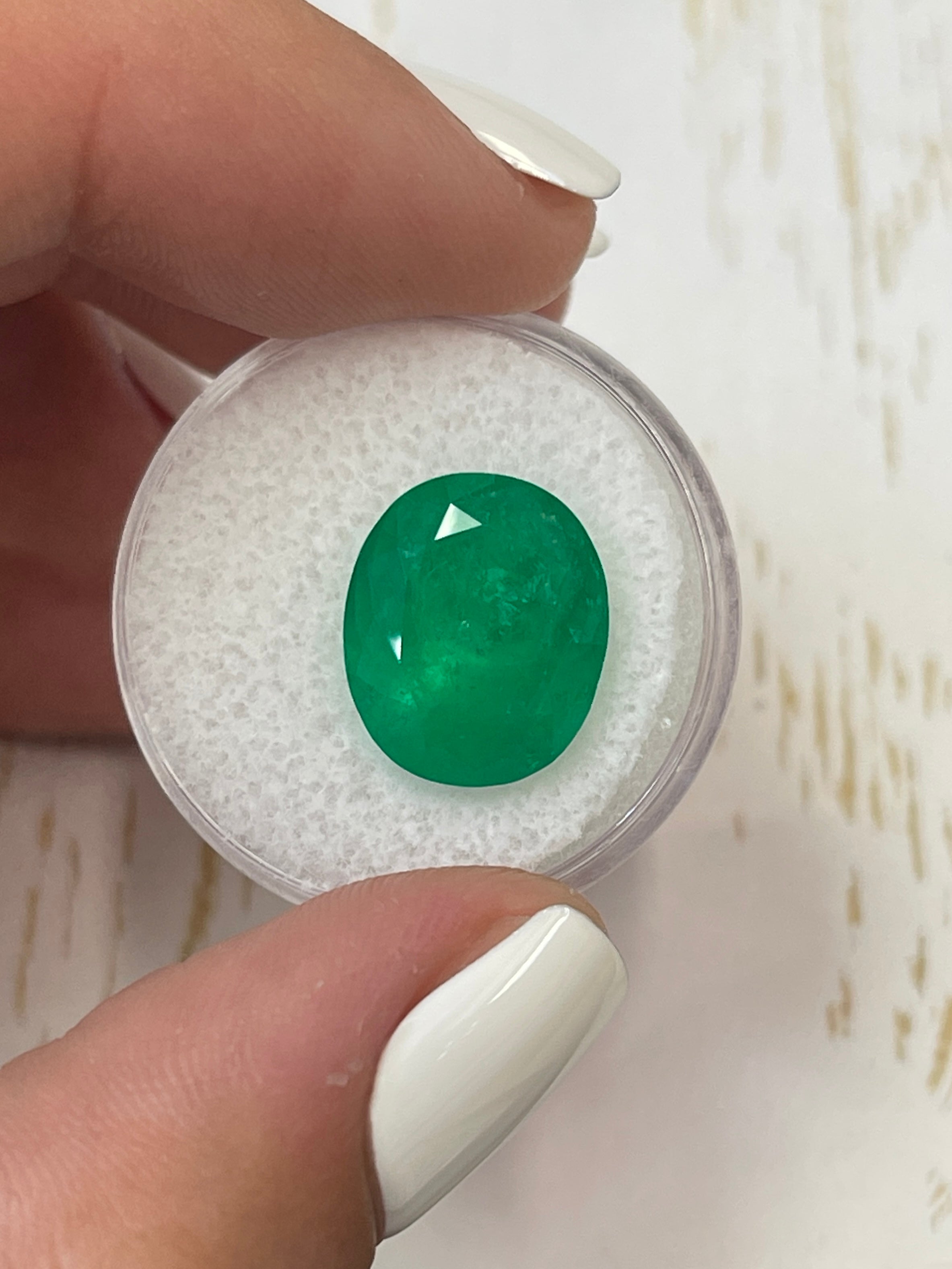 Deep green 8.29 carat natural Colombian emerald in oval cut, showing rich color and clarity, from JR Colombian Emeralds.