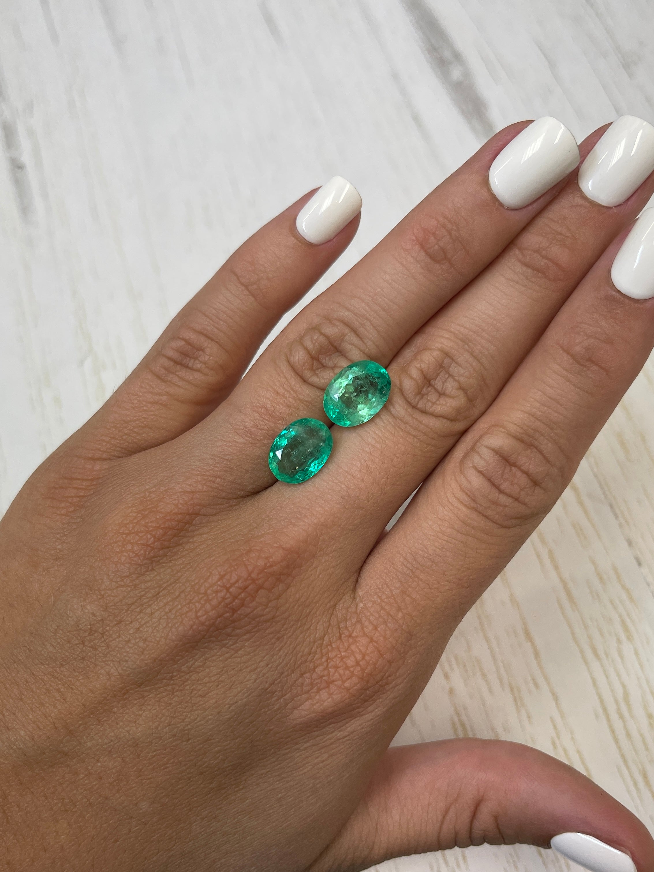 Oval cut Colombian emeralds totaling 9.02 carats in a matching loose gemstone set by JR Colombian Emeralds.