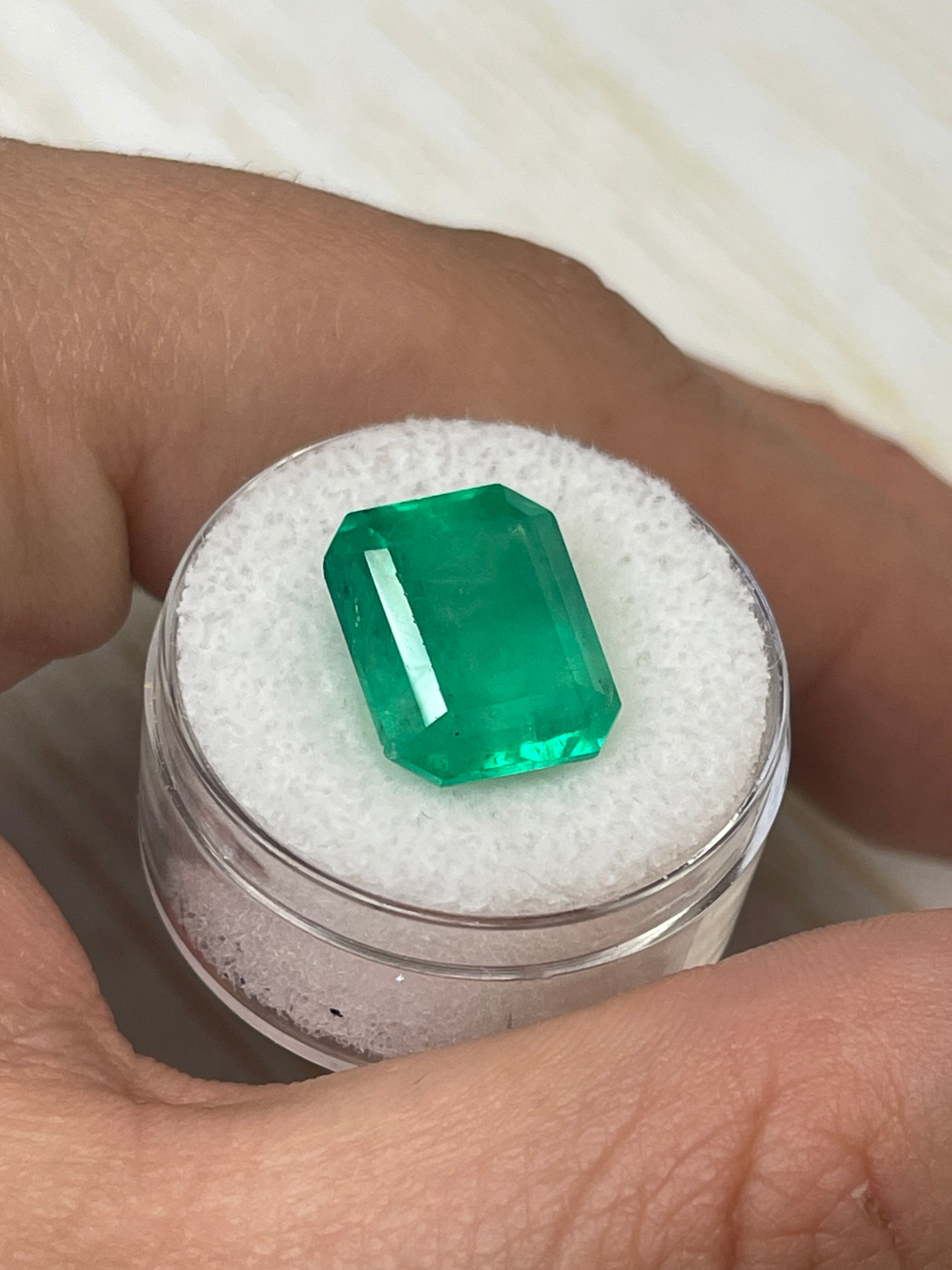 9.28-carat yellowish-green Colombian emerald cut loose gemstone from JR Colombian Emeralds, showcasing a vibrant emerald shape.