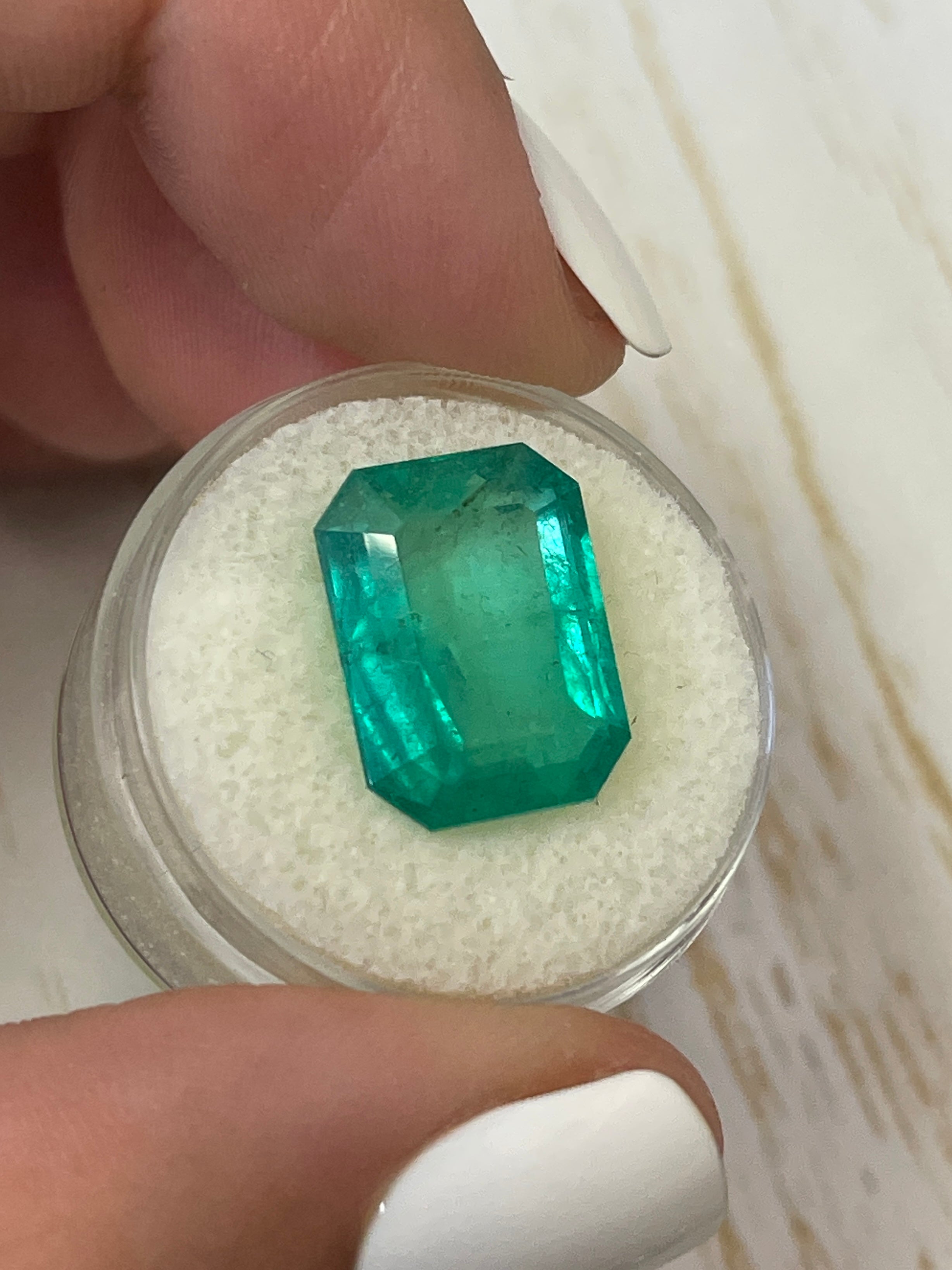 Large 9.52 carat natural Colombian emerald in an emerald cut, showcasing vibrant green color and clarity.