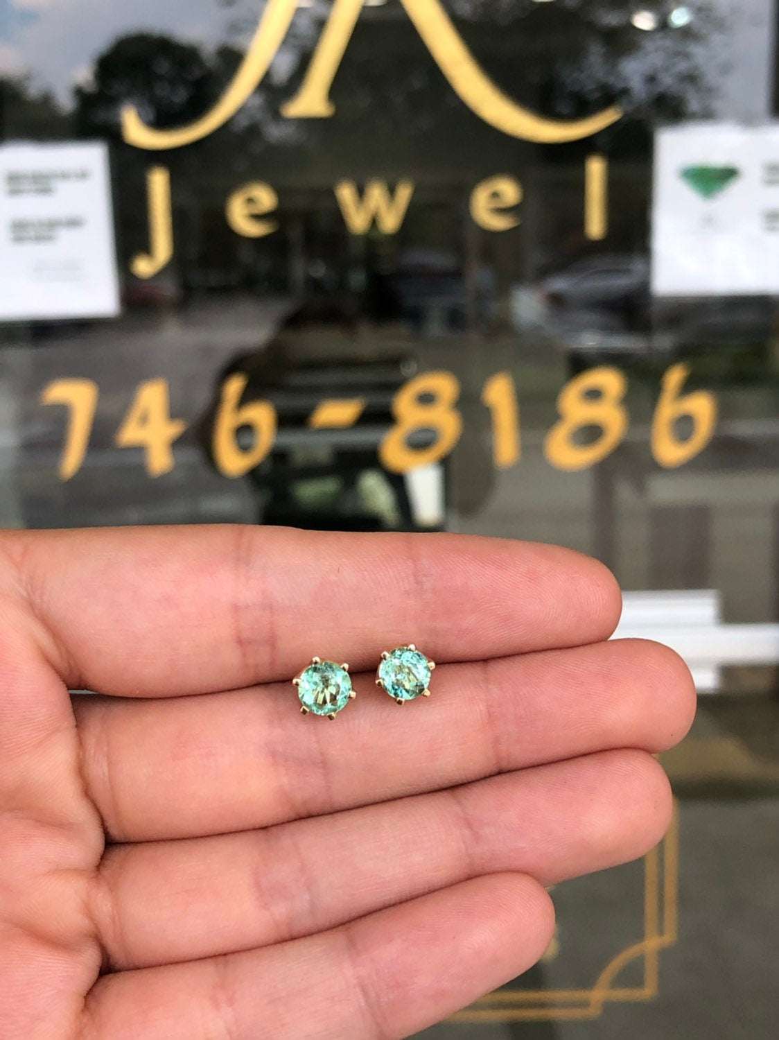 JR Colombian Emeralds 14K gold earrings with round, rich bright green emeralds in a six-prong setting, totaling 1.56 tcw.