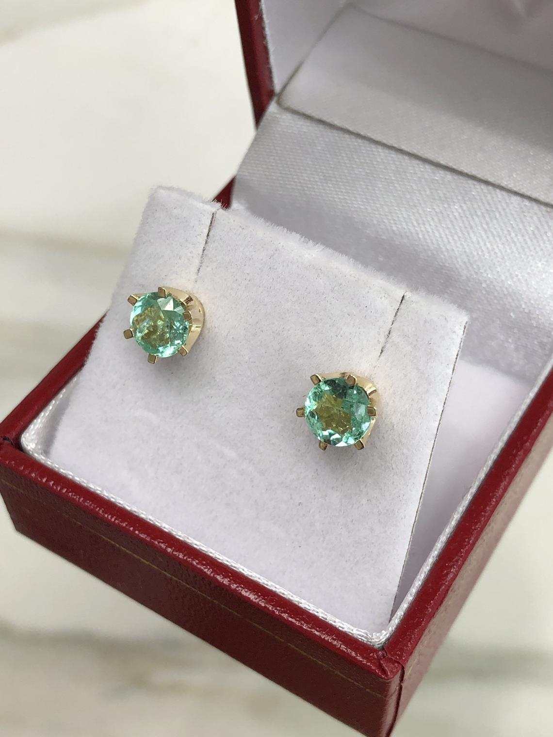 JR Colombian Emeralds 14K gold earrings with round, six-prong setting and rich bright green emeralds, totaling 1.56 carats.