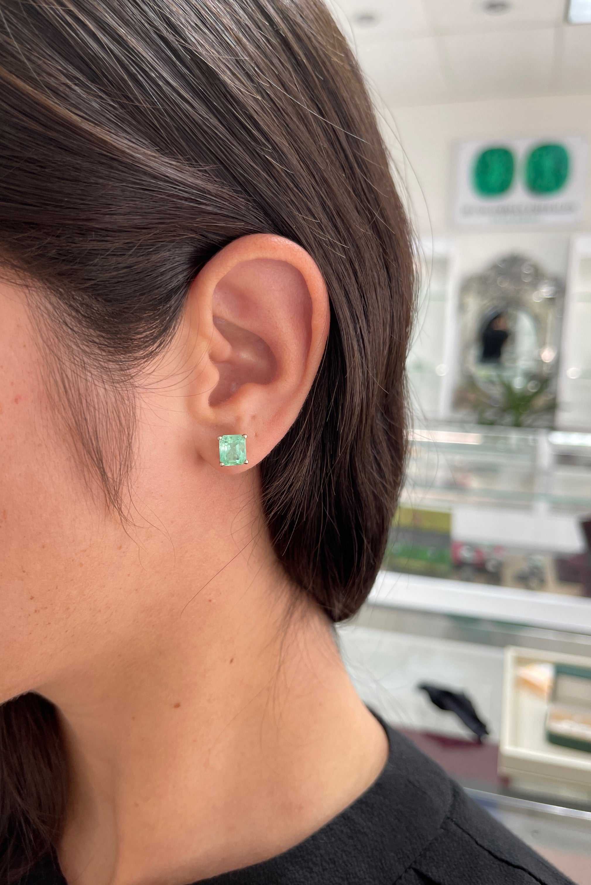 18K white gold Colombian emerald stud earrings with light green martini-cut emeralds, totaling 3.46 carats.