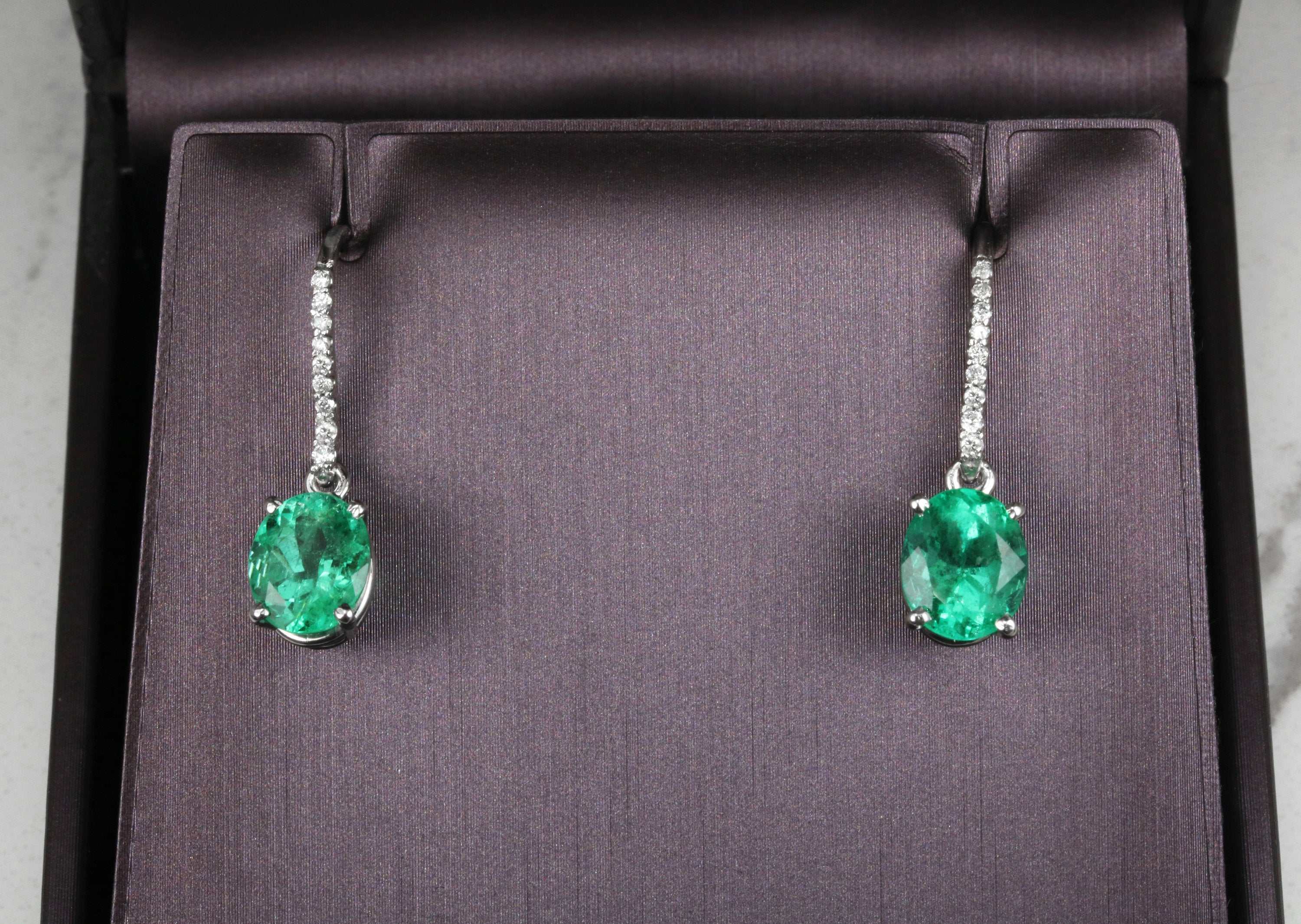 Fine quality vivid green Colombian emerald oval and diamond dangle earrings in 14K gold by JR Colombian Emeralds.