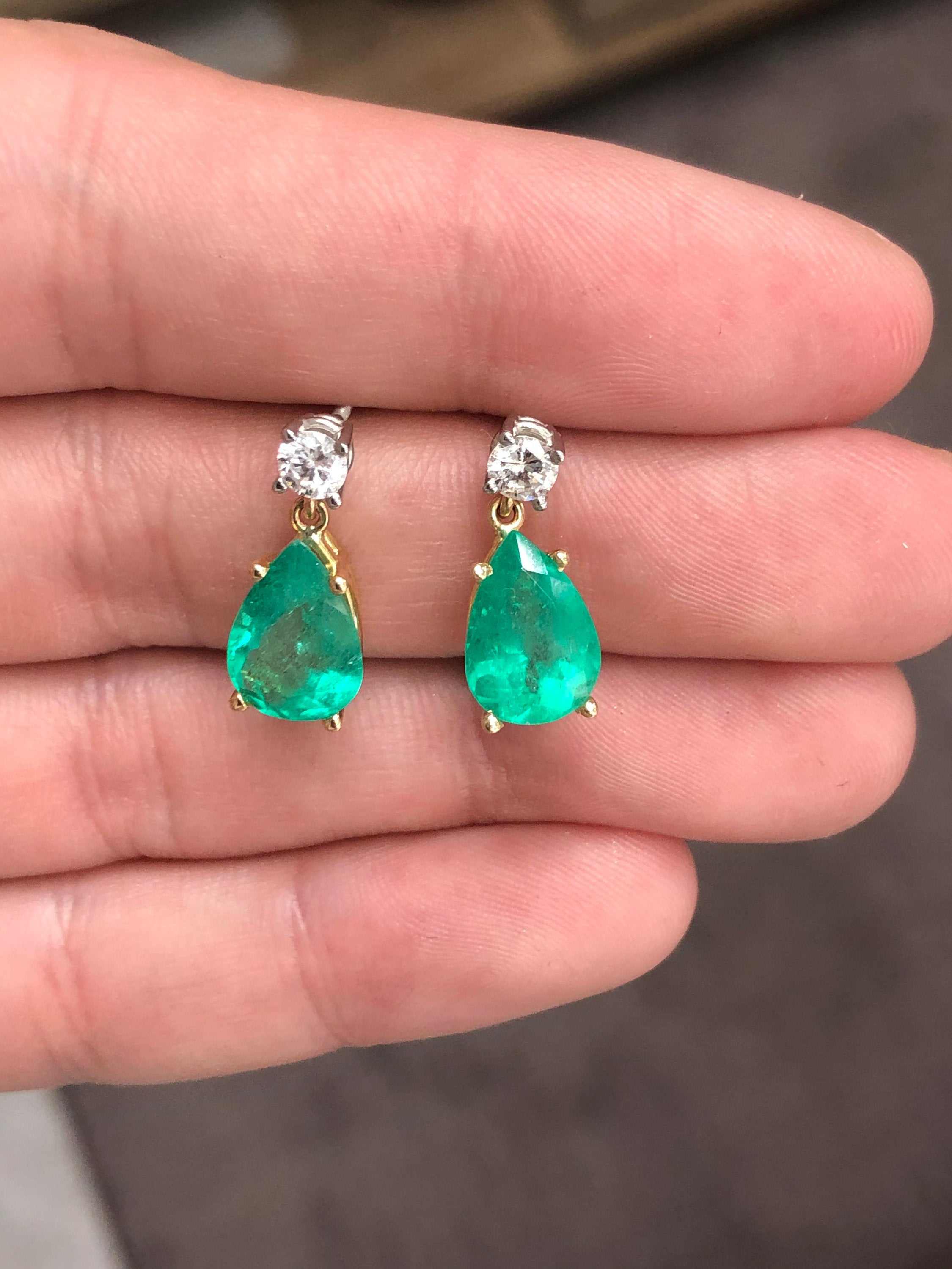 Natural tear drop emerald and diamond dangle earrings in 14K gold by JR Colombian Emeralds, featuring 5.80 carats of gemstones.