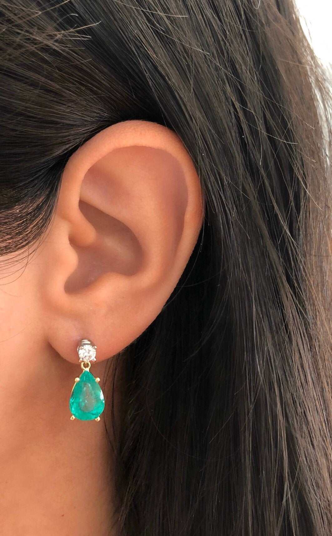 Natural tear drop emerald and diamond dangle earrings in 14K gold with JR Colombian Emeralds branding.