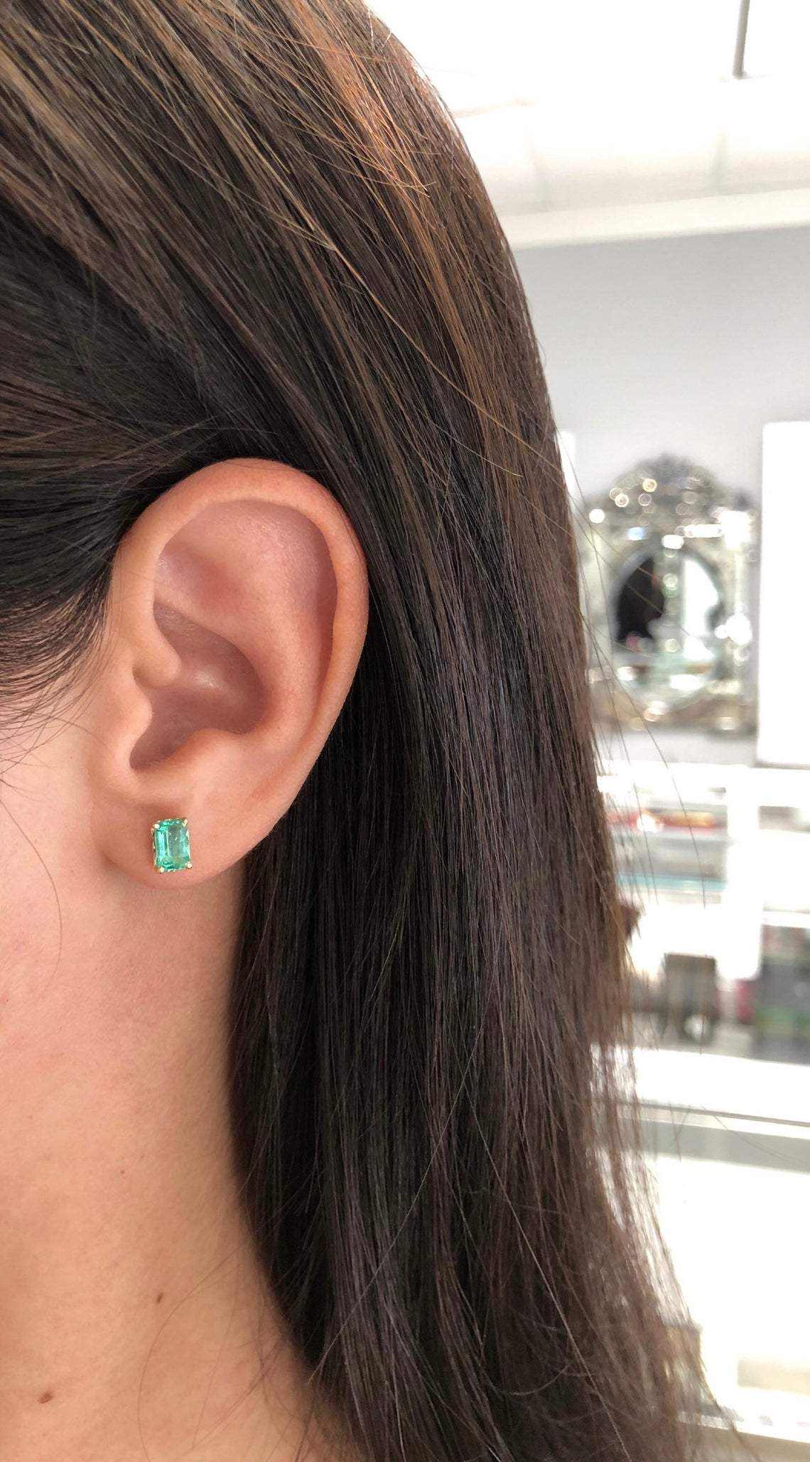 Trendy 1.50ctw Colombian emerald cut stud earrings by JR Colombian Emeralds in 14K gold, featuring classic fleur de lis design.