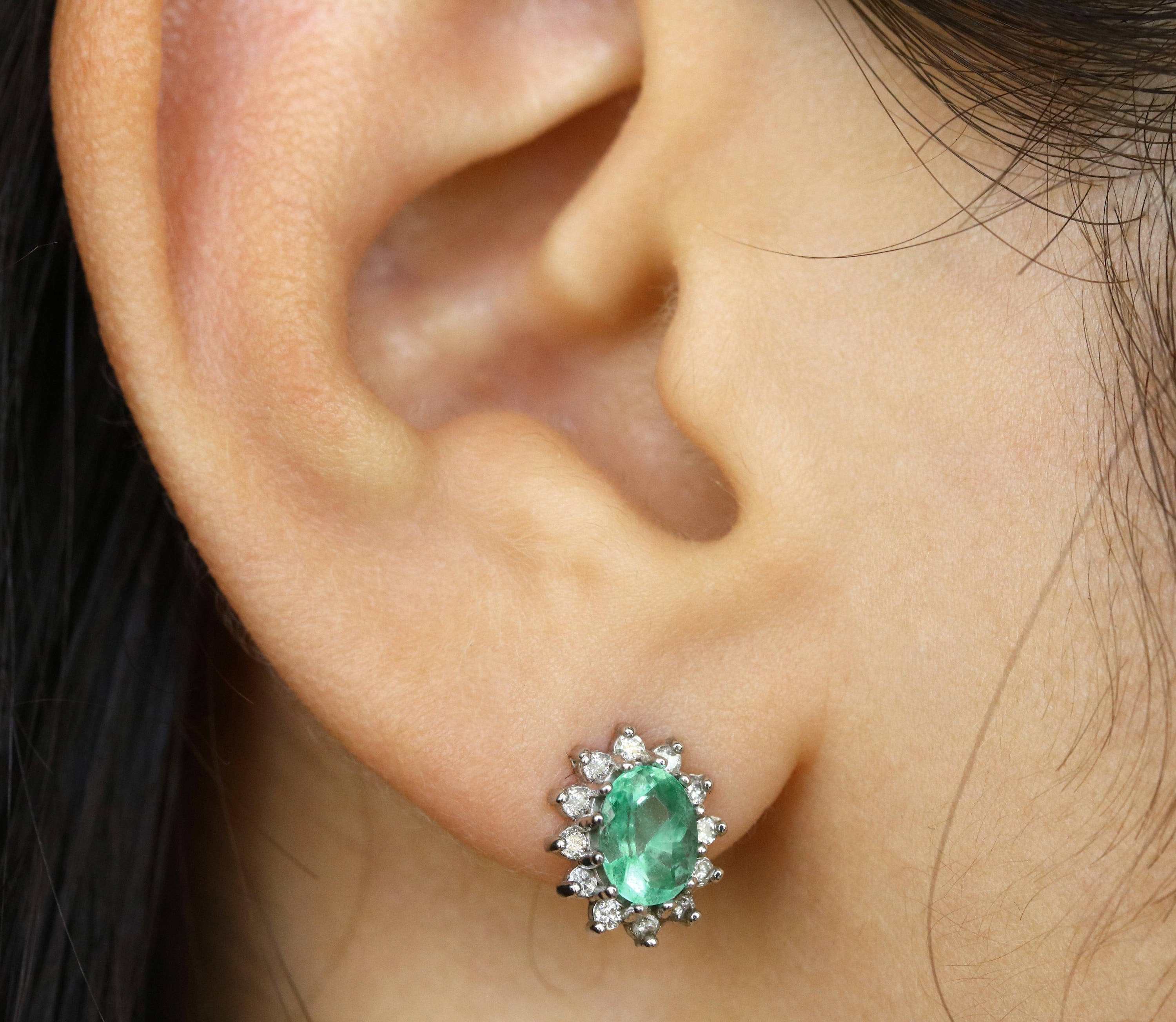 14K gold emerald and diamond cluster halo earrings featuring oval and round cut gemstones by JR Colombian Emeralds.