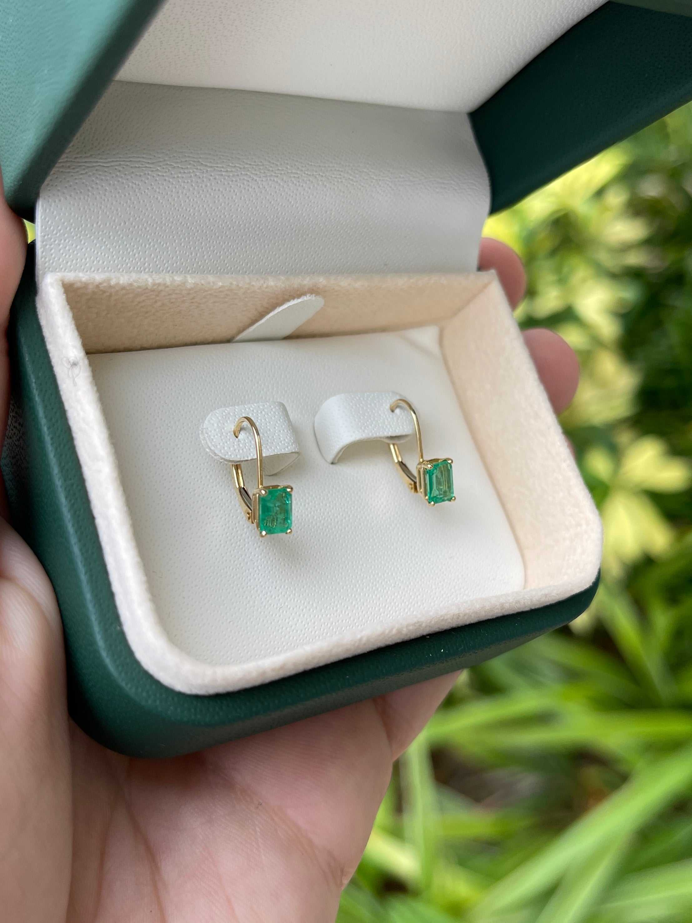 Emerald cut natural emerald earrings with 1.50tcw prong-set gemstones in 14K yellow gold, lever-back style by JR Colombian Emeralds.