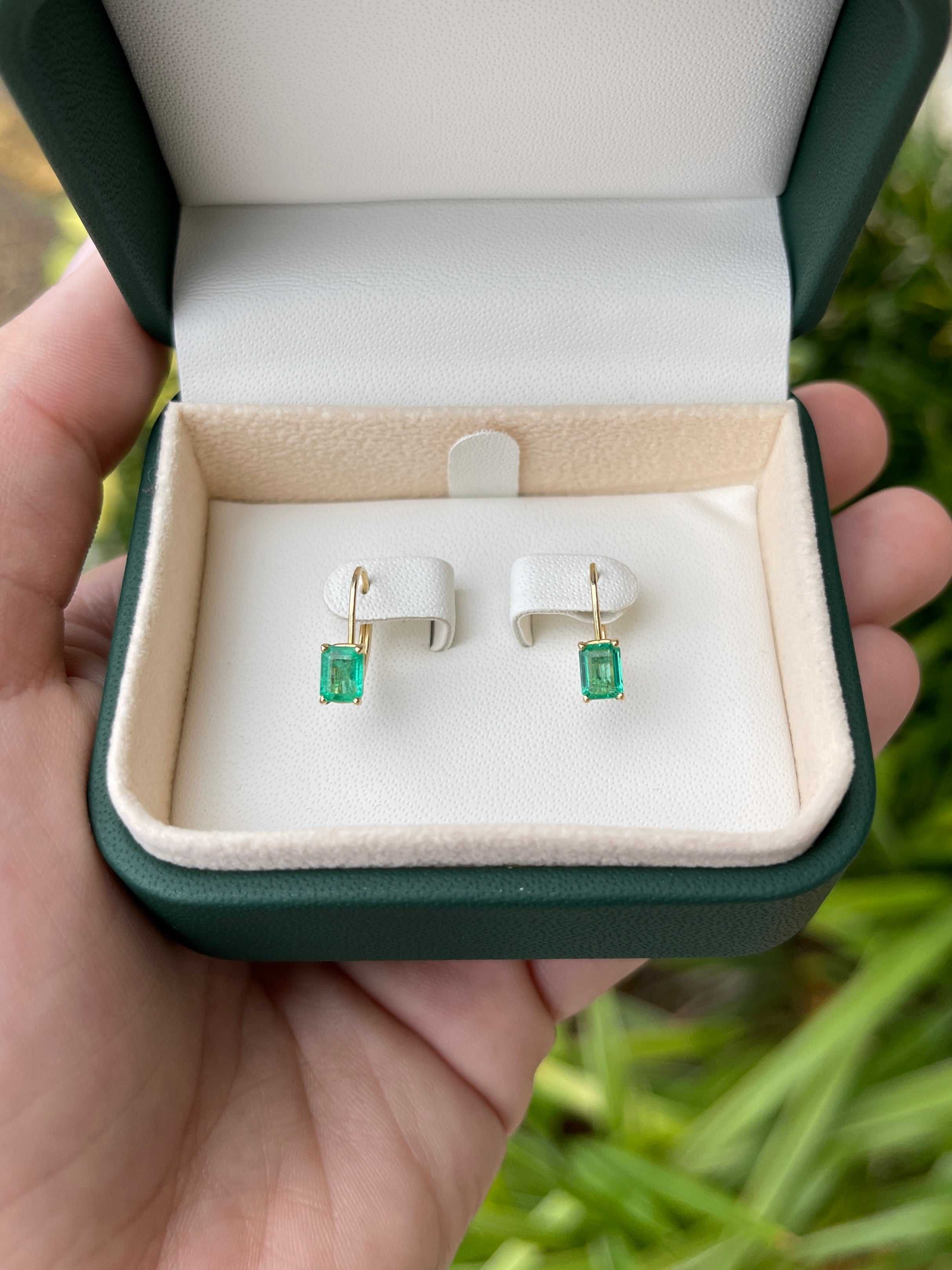 JR Colombian Emeralds 14K yellow gold earrings with 1.50tcw natural emerald-cut emeralds, prong set with lever back closure.