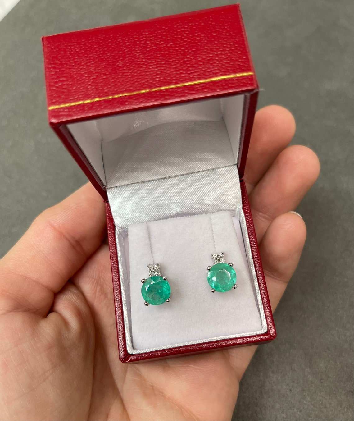 JR Colombian Emeralds 14K gold stud earrings with 4.32tcw round blue-green Colombian emeralds and diamond accents.