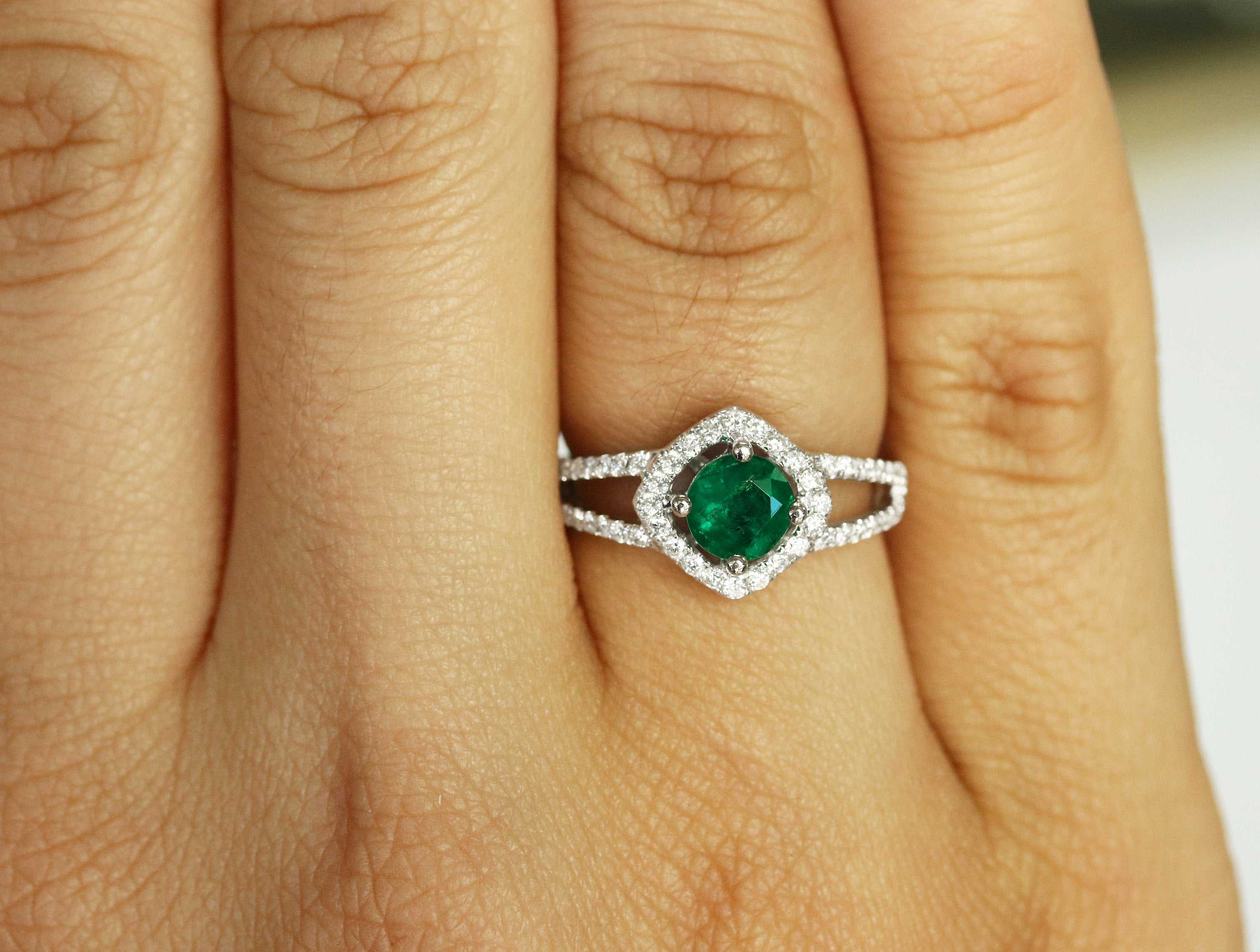 Emerald and diamond halo engagement ring with split shank design by JR Colombian Emeralds, featuring a 1.39tcw central stone.