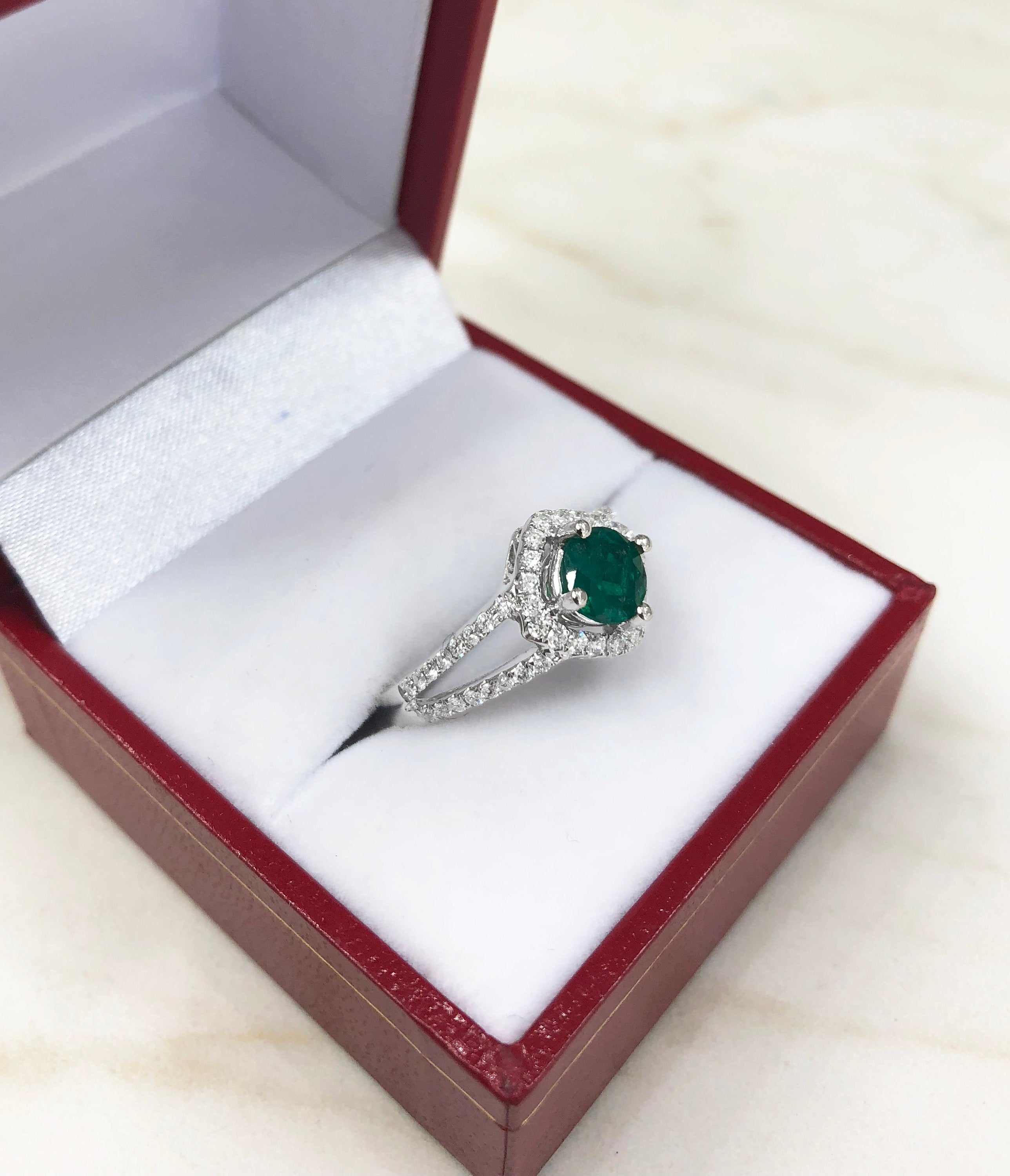 JR Colombian Emeralds engagement ring with 1.39tcw split shank, emerald center stone, diamond halo, and elegant design.