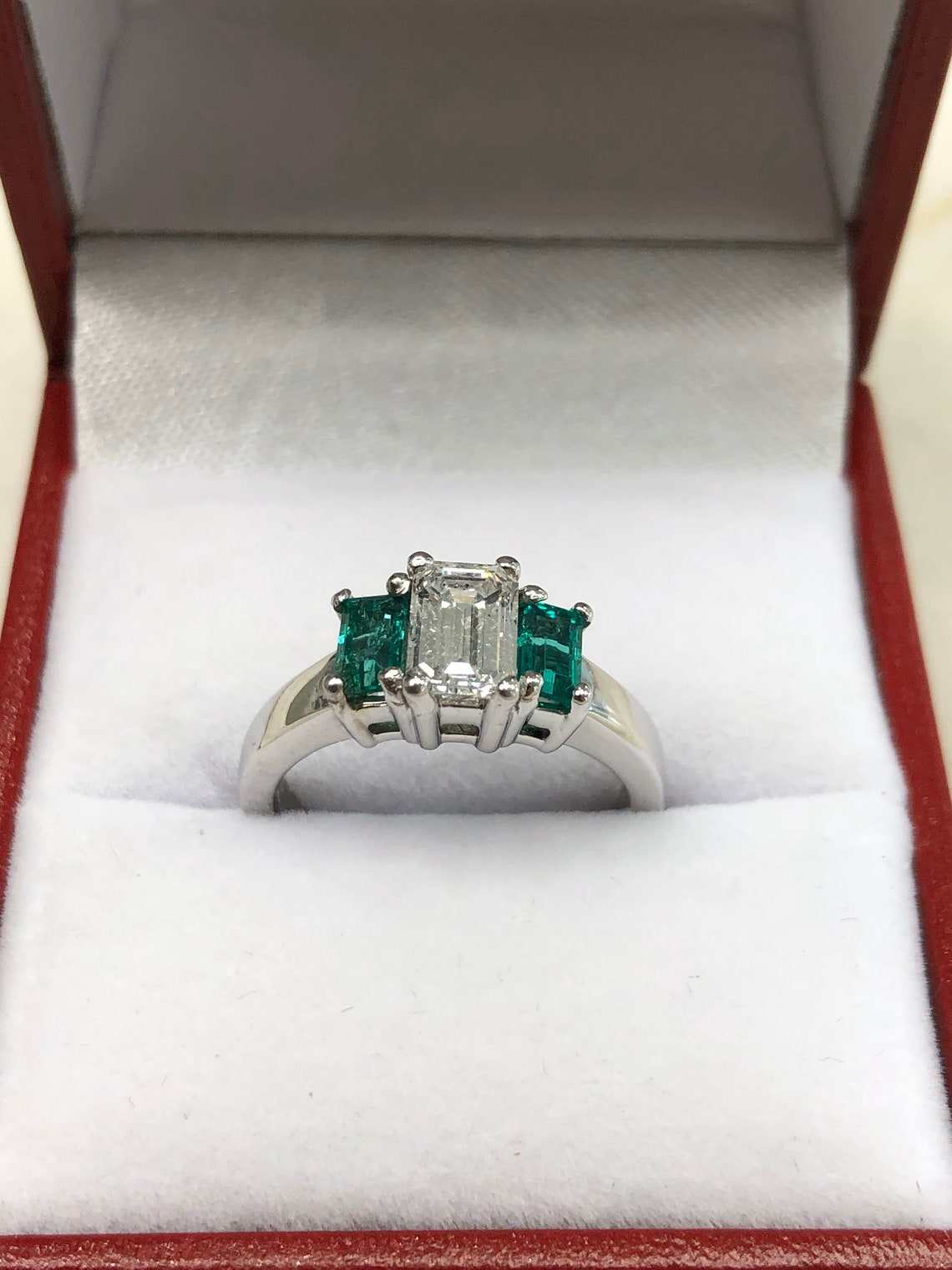 JR Colombian Emeralds 1.27tcw classic three-stone engagement ring in 14K gold featuring diamonds and emeralds.
