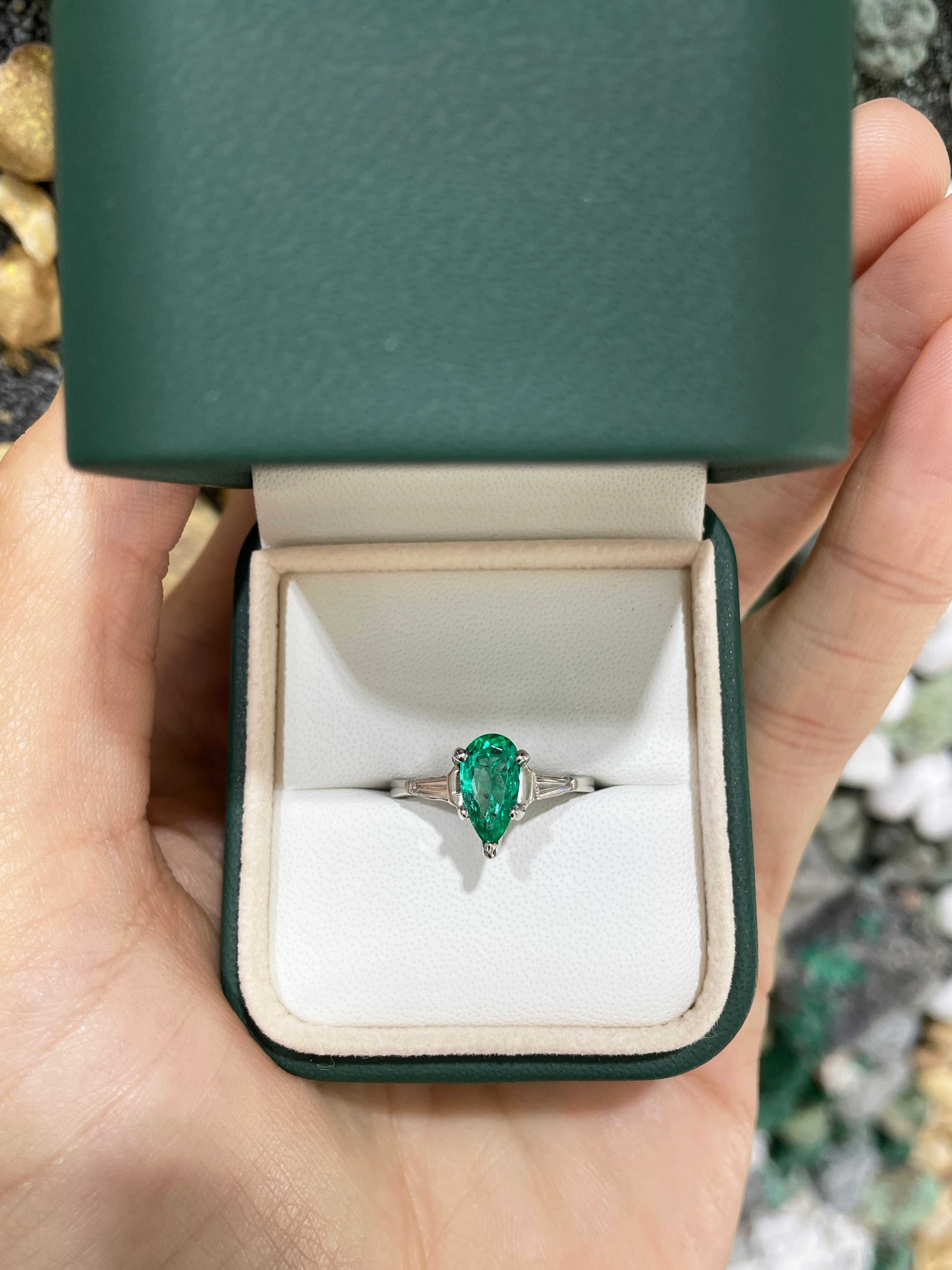 Brilliant pear cut Colombian emerald and tapered baguette diamond engagement ring in 18K gold by JR Colombian Emeralds.