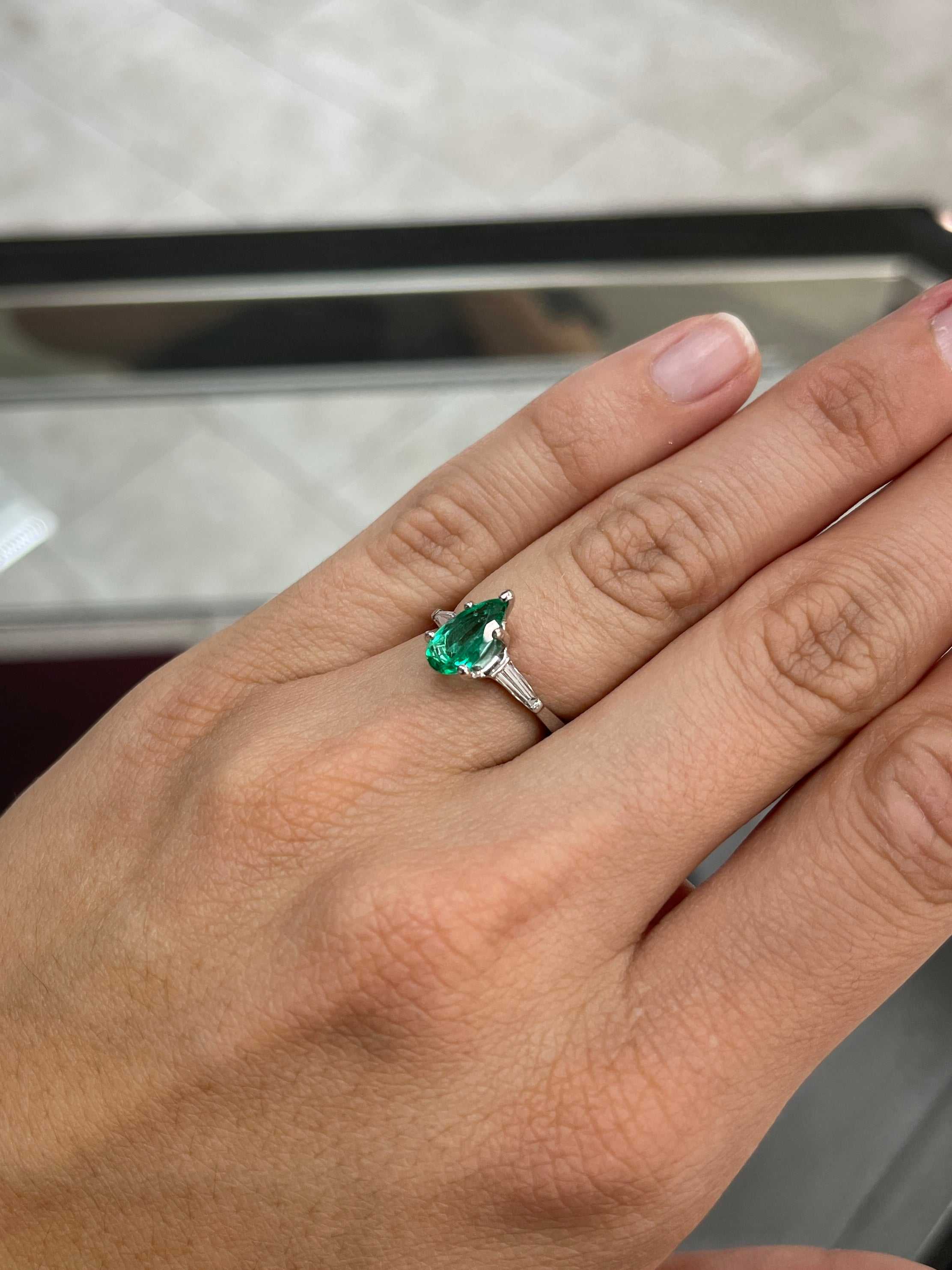 Brilliant pear cut Colombian emerald and tapered baguette diamond engagement ring in 18K gold by JR Colombian Emeralds.
