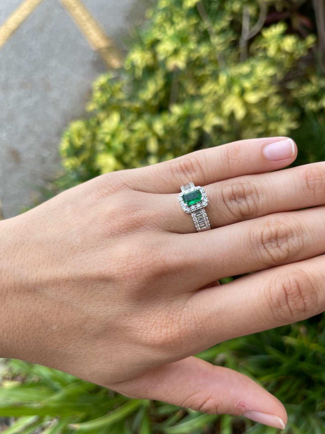 Natural green emerald and diamond engagement ring by JR Colombian Emeralds with round and baguette diamonds in 14K gold.