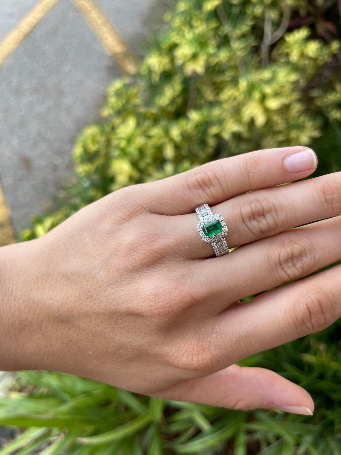 Natural green emerald and diamond engagement ring by JR Colombian Emeralds featuring round and baguette diamonds in 14K gold.