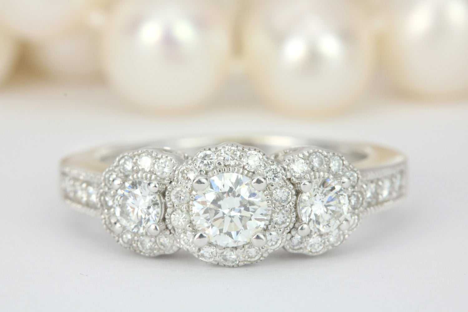 1.46tcw scalloped diamond halo engagement ring in 14K white gold with three brilliant round diamonds and filigree detail