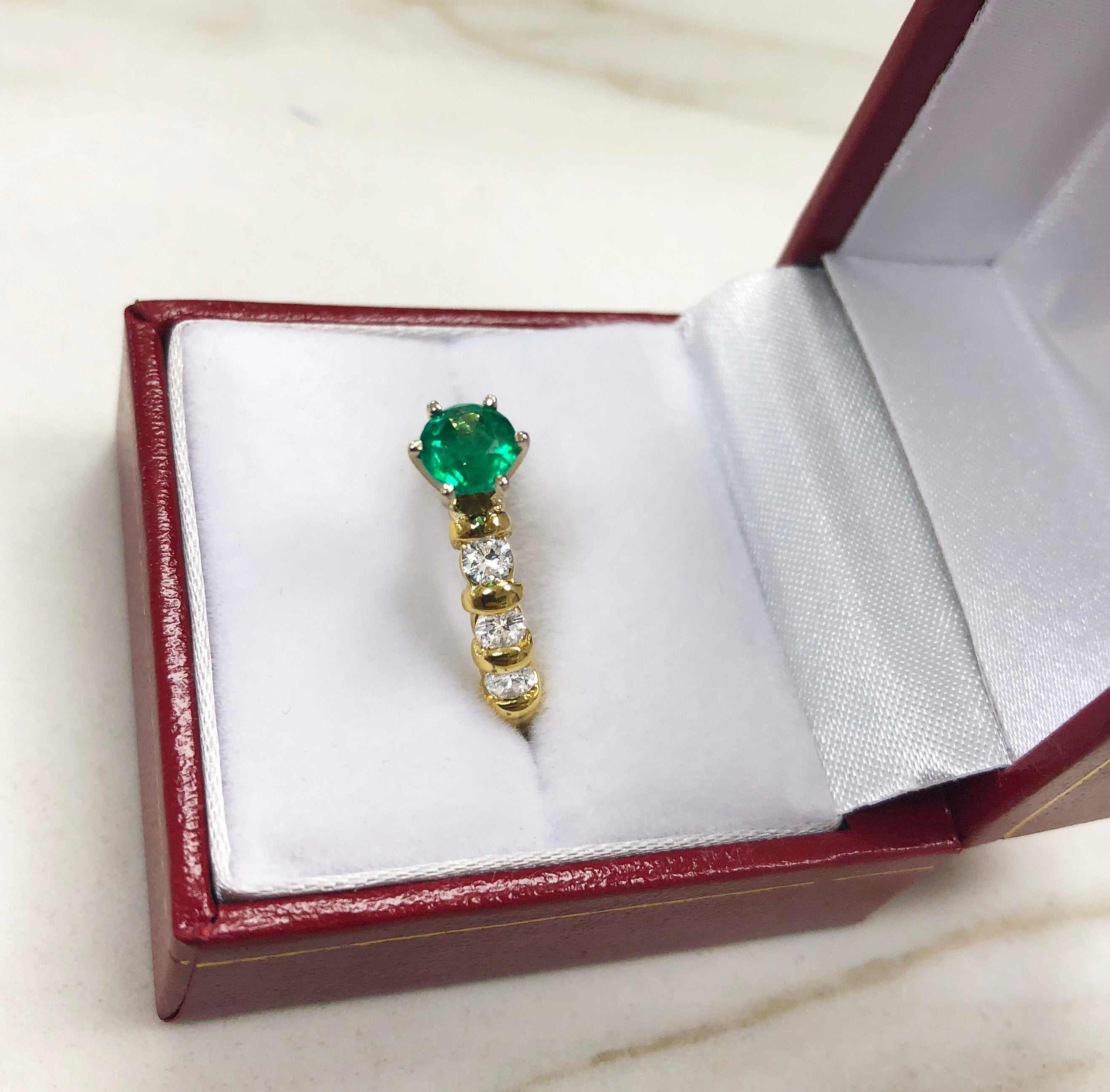 JR Colombian Emeralds 1.69tcw round emerald and diamond accent engagement ring in 18K yellow gold, showcasing elegant gemstone details.