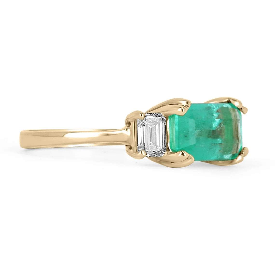 Three stone emerald and diamond engagement ring in 14K gold by JR Colombian Emeralds, showcasing vibrant green stones.