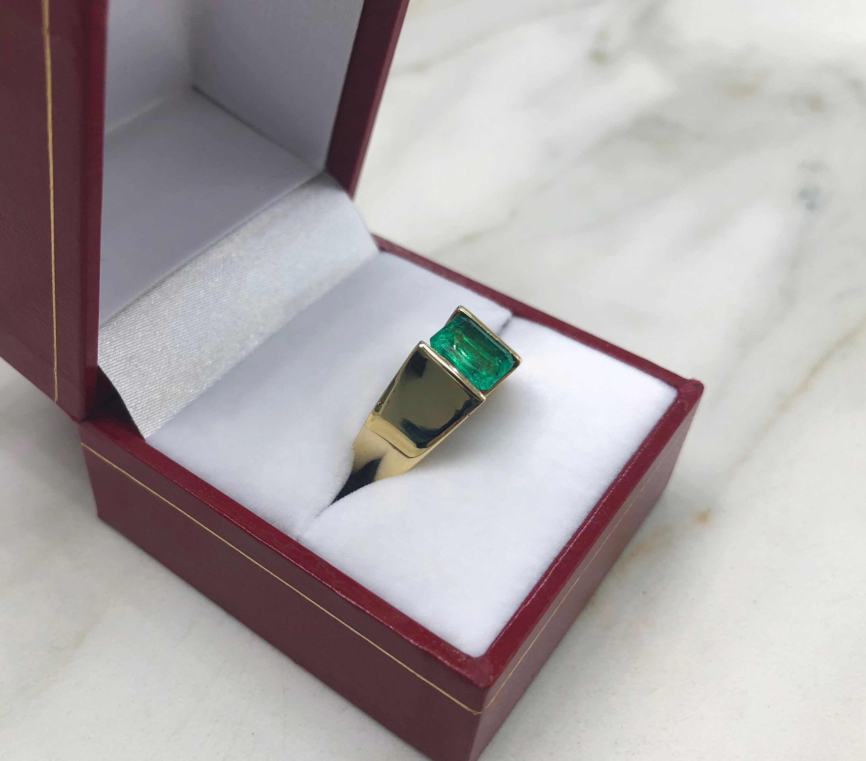 JR Colombian Emeralds men's ring in 14K yellow gold featuring a 2.0 carat vivid green emerald-cut solitaire gemstone.