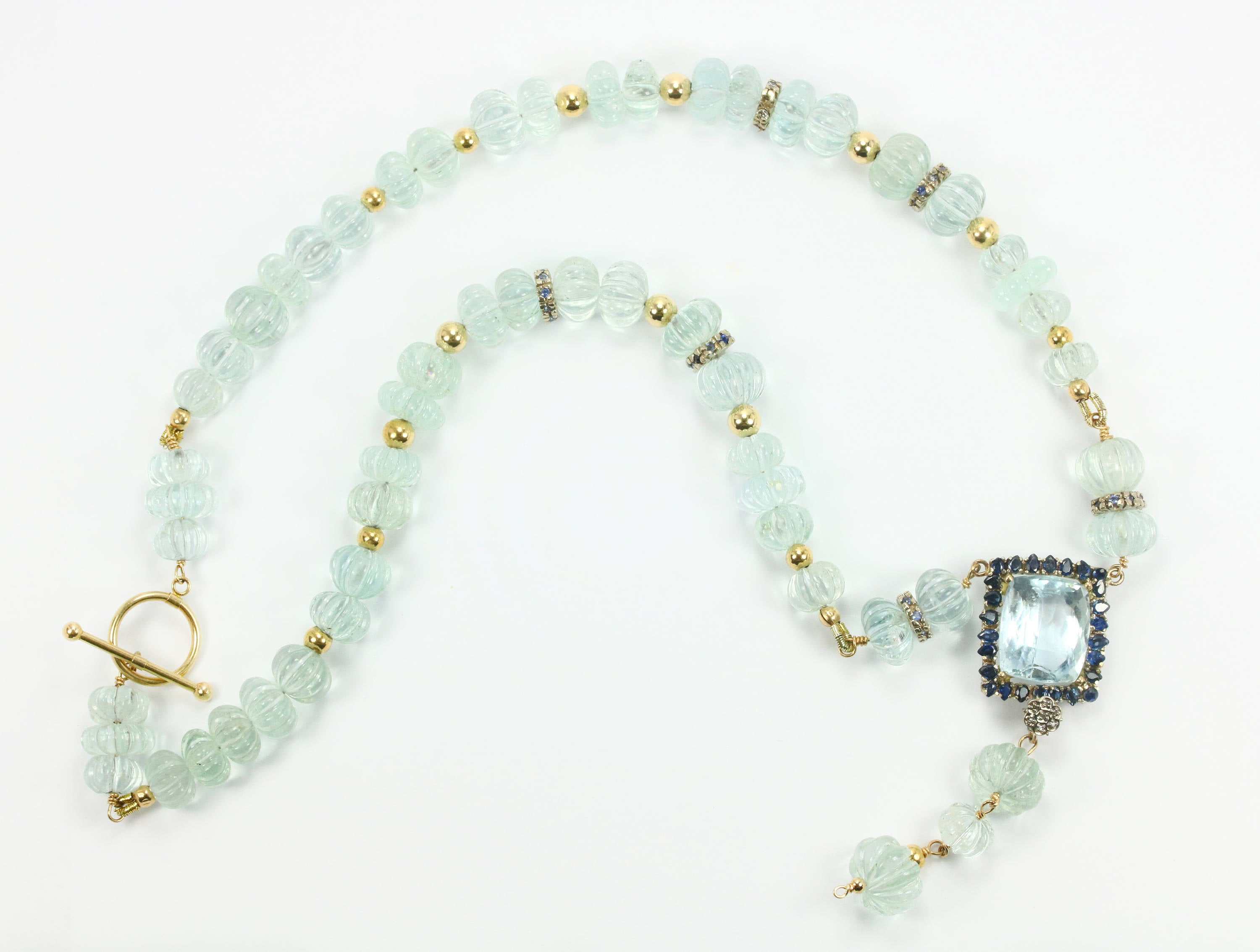 288cts natural aquamarine and sapphire lariat necklace with hand carved melon beads and 14K gold setting