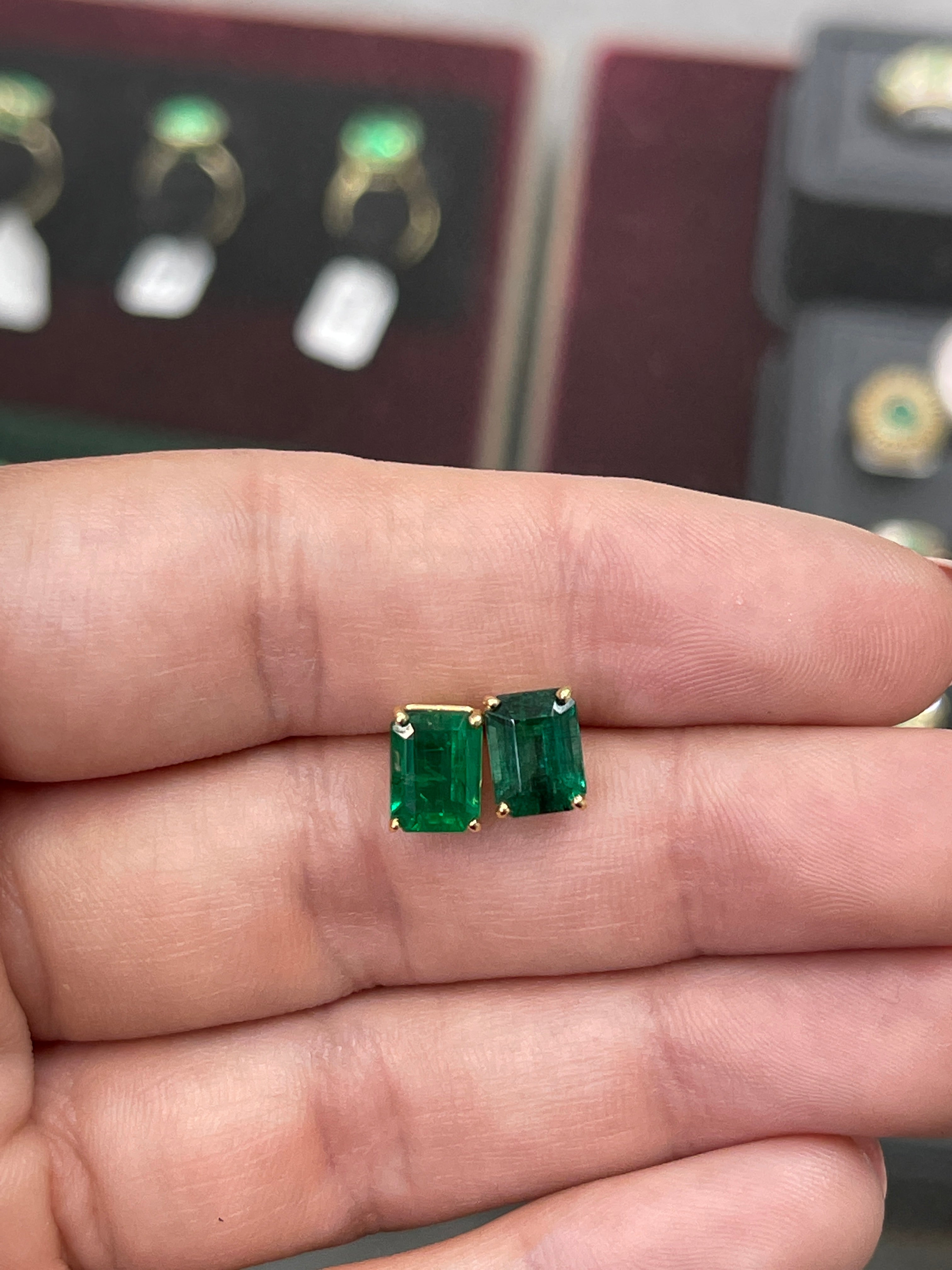 Vivid dark forest green emerald cut diamond stud earrings in solid 18K gold, featuring AAA 5.0TCW gemstones by JR Colombian Emeralds.